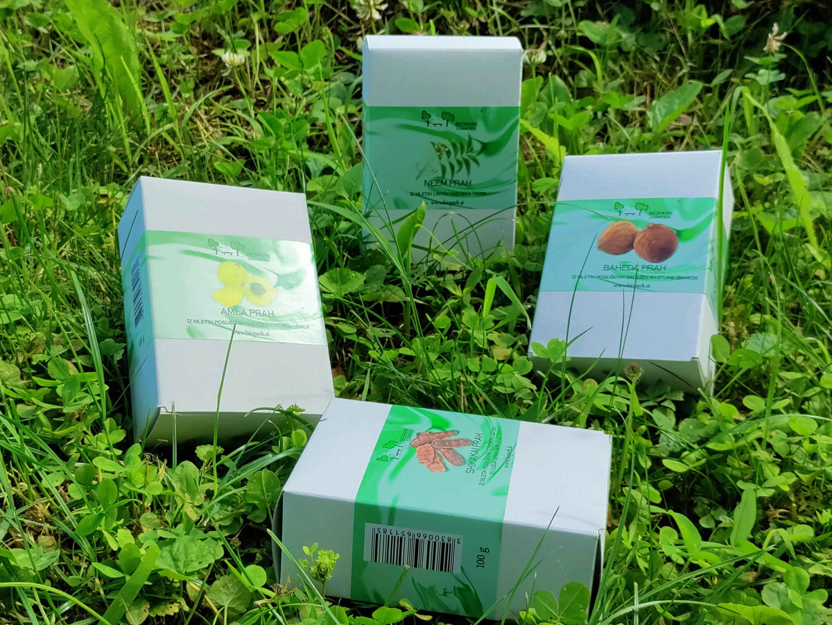 Four boxes with green labels on a grassy background
