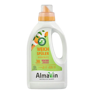 A bottle of AlmaWin softener for washing machines, featuring a white plastic body, a green and orange label, and an orange cap, shown on a plain white background.