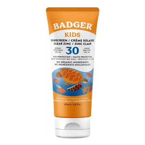 A tube of Badger Kids sunscreen, shade Clear Zinc, featuring an orange and white design with a blue underwater illustration of a sea turtle and fish. The text is printed in English and French.