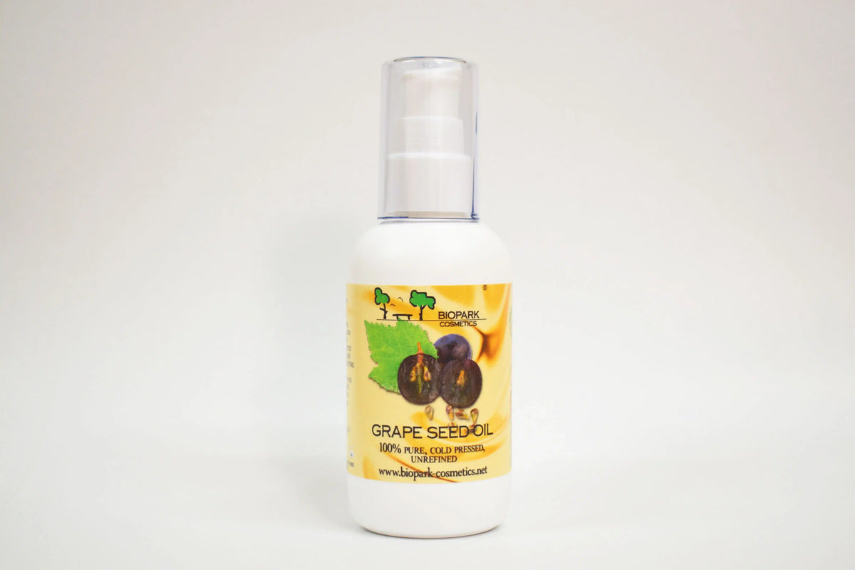 Bottle of grape seed oil with a label on a white background