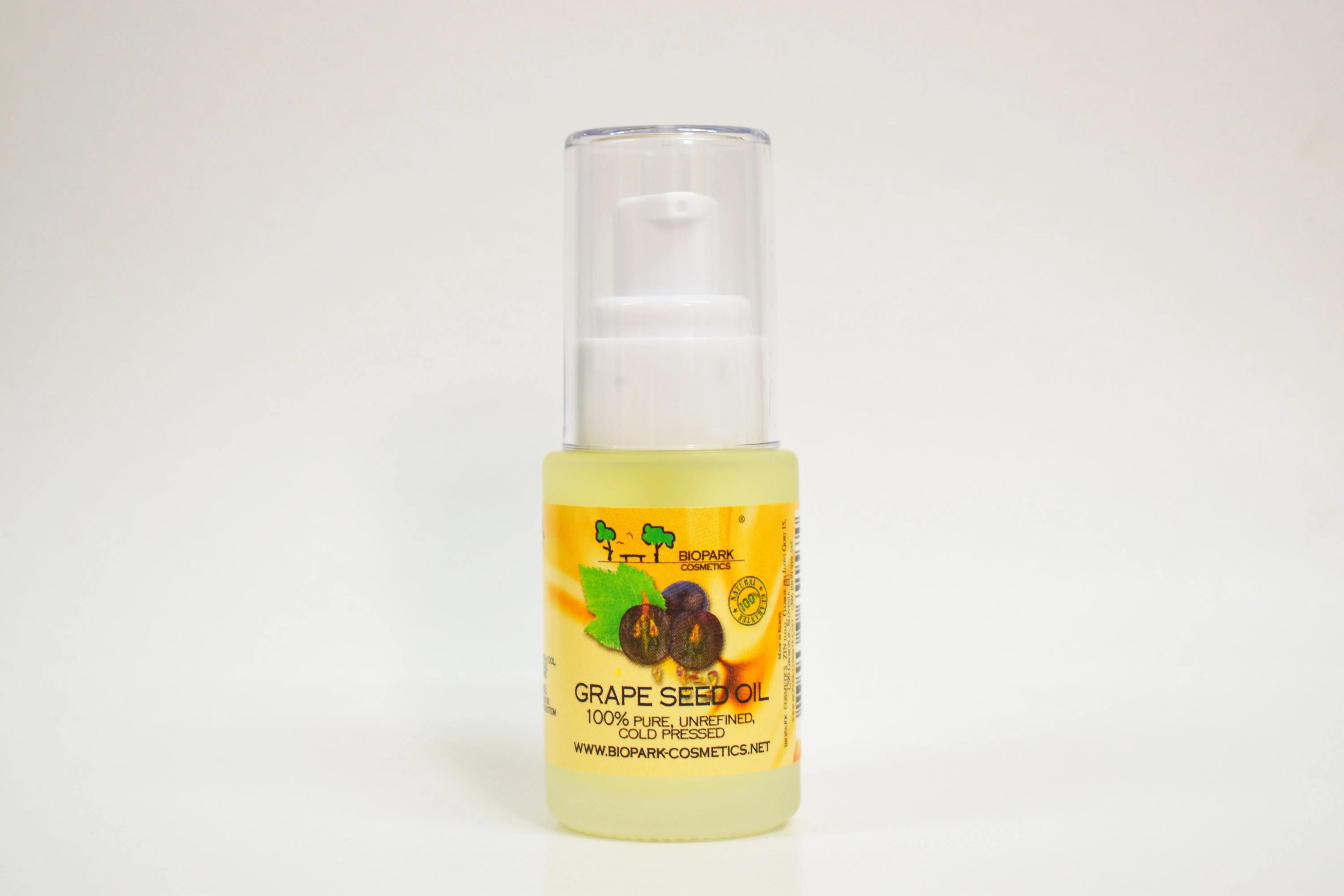 Bottle of grape seed oil with a white background