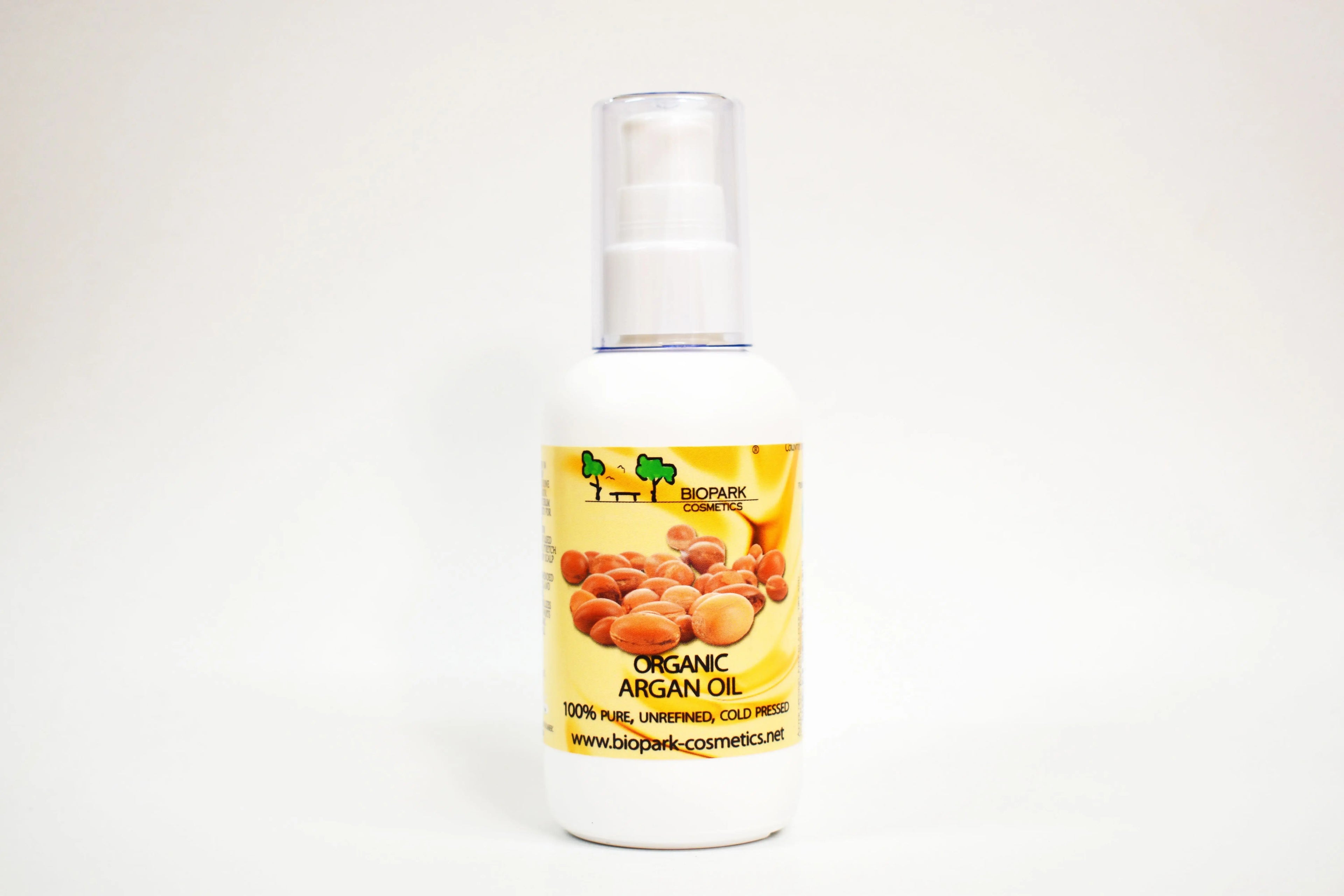 Bottle of organic argan oil with a yellow label on a white background