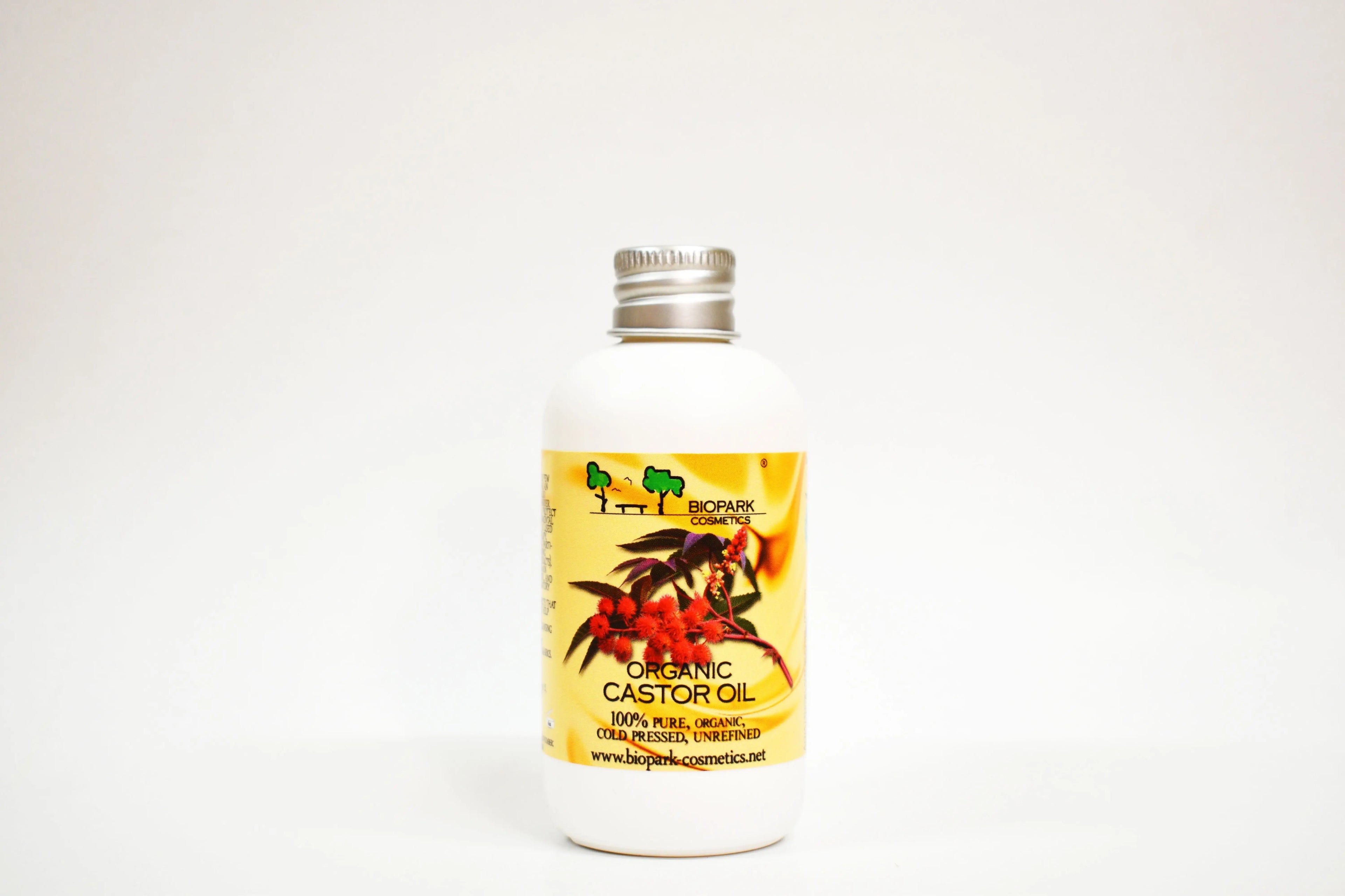 Bottle of organic castor oil with a visible label on a white background