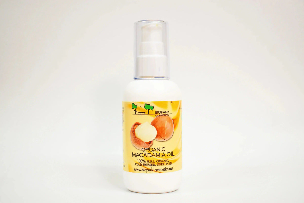 Bottle of organic macadamia oil with a yellow label on a white background
