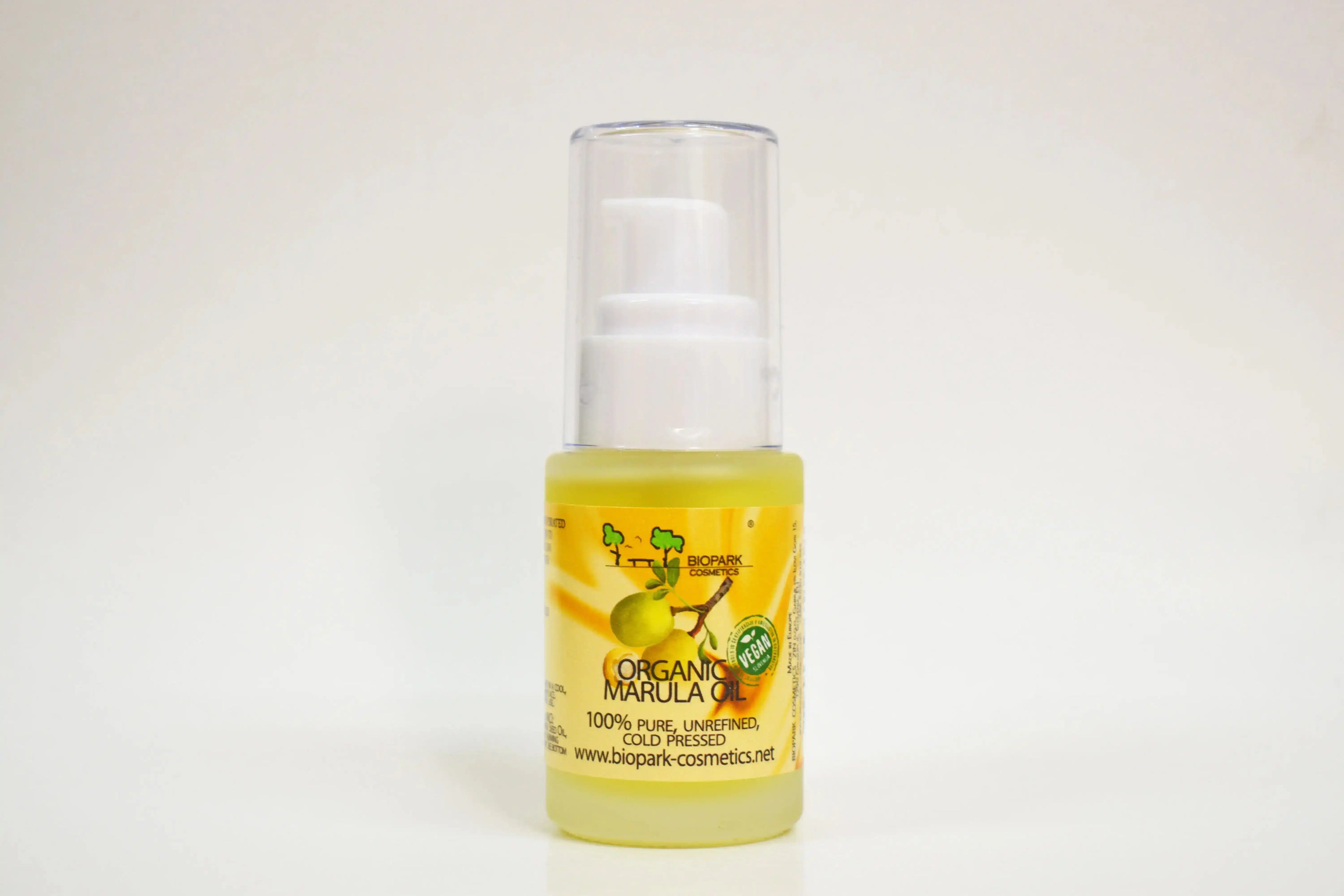 Bottle of organic marula oil on a white background