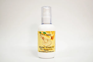 Bottle of organic sesame oil with a yellow label on a white background