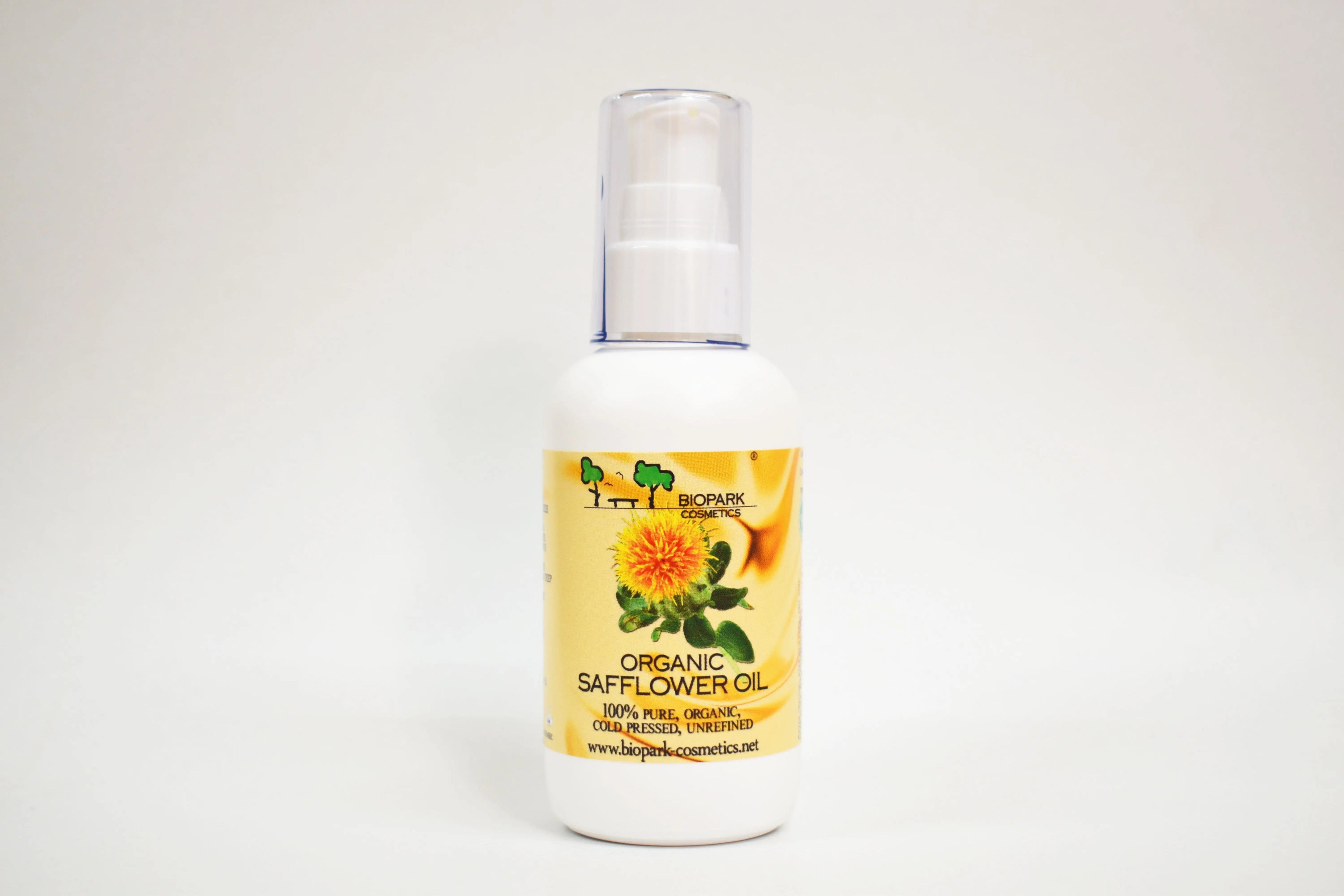 Bottle of organic safflower oil with a yellow label on a white background