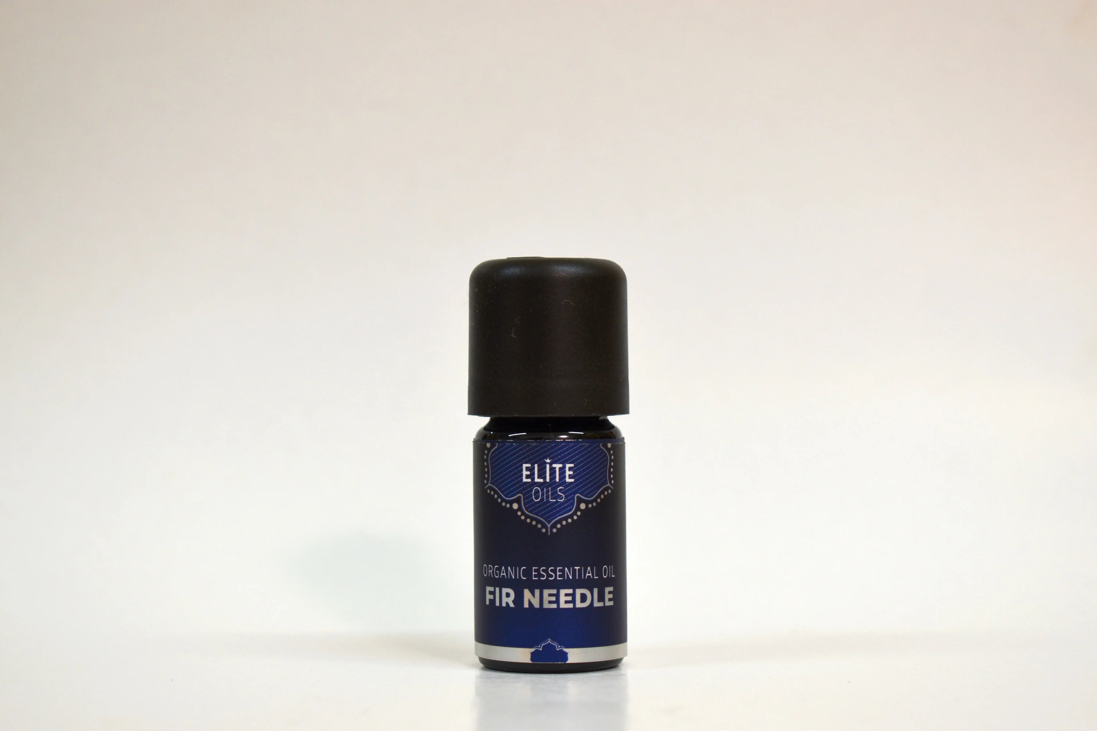 Bottle of Elite Oils Fir Needle essential oil on a white background