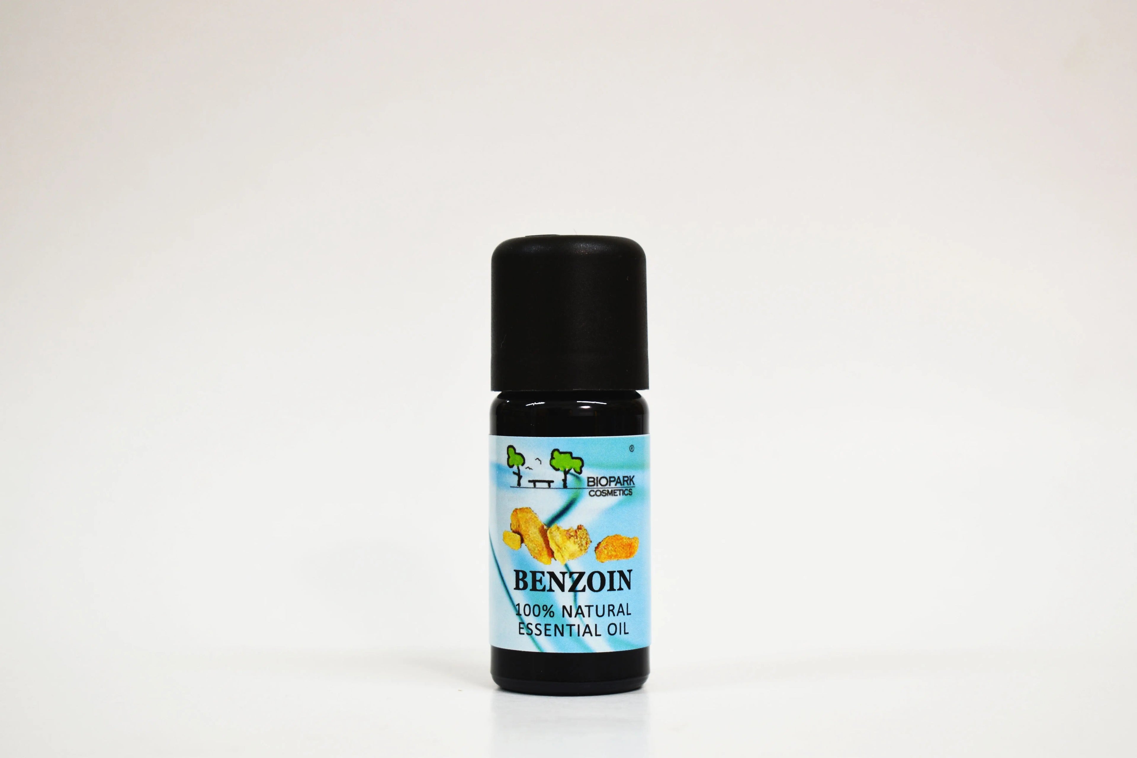 Bottle of benzoin essential oil on a white background