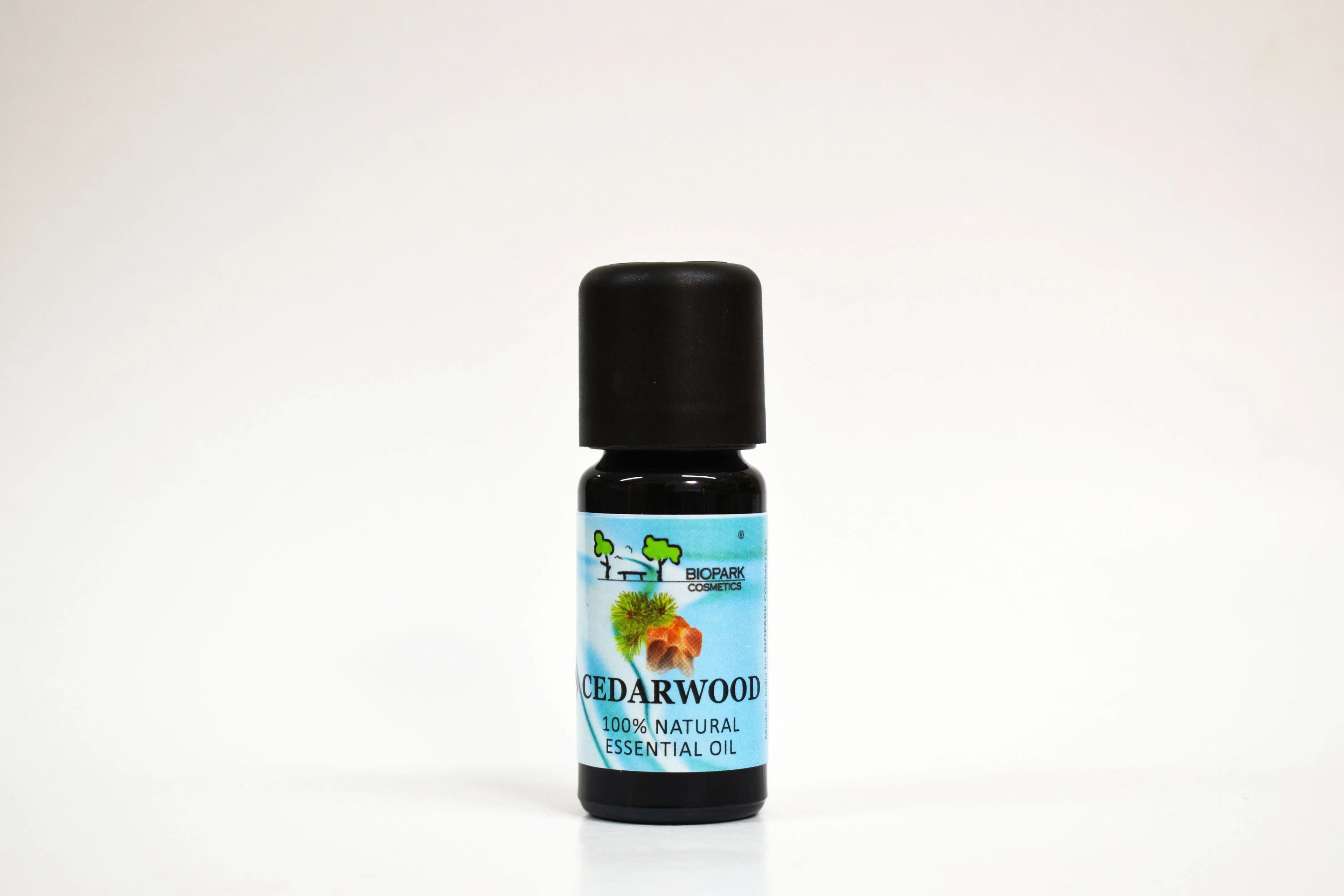 Bottle of Cedarwood essential oil on a white background
