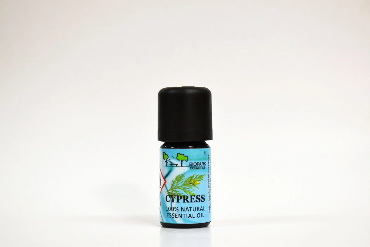 Bottle of Cypress essential oil on a white background