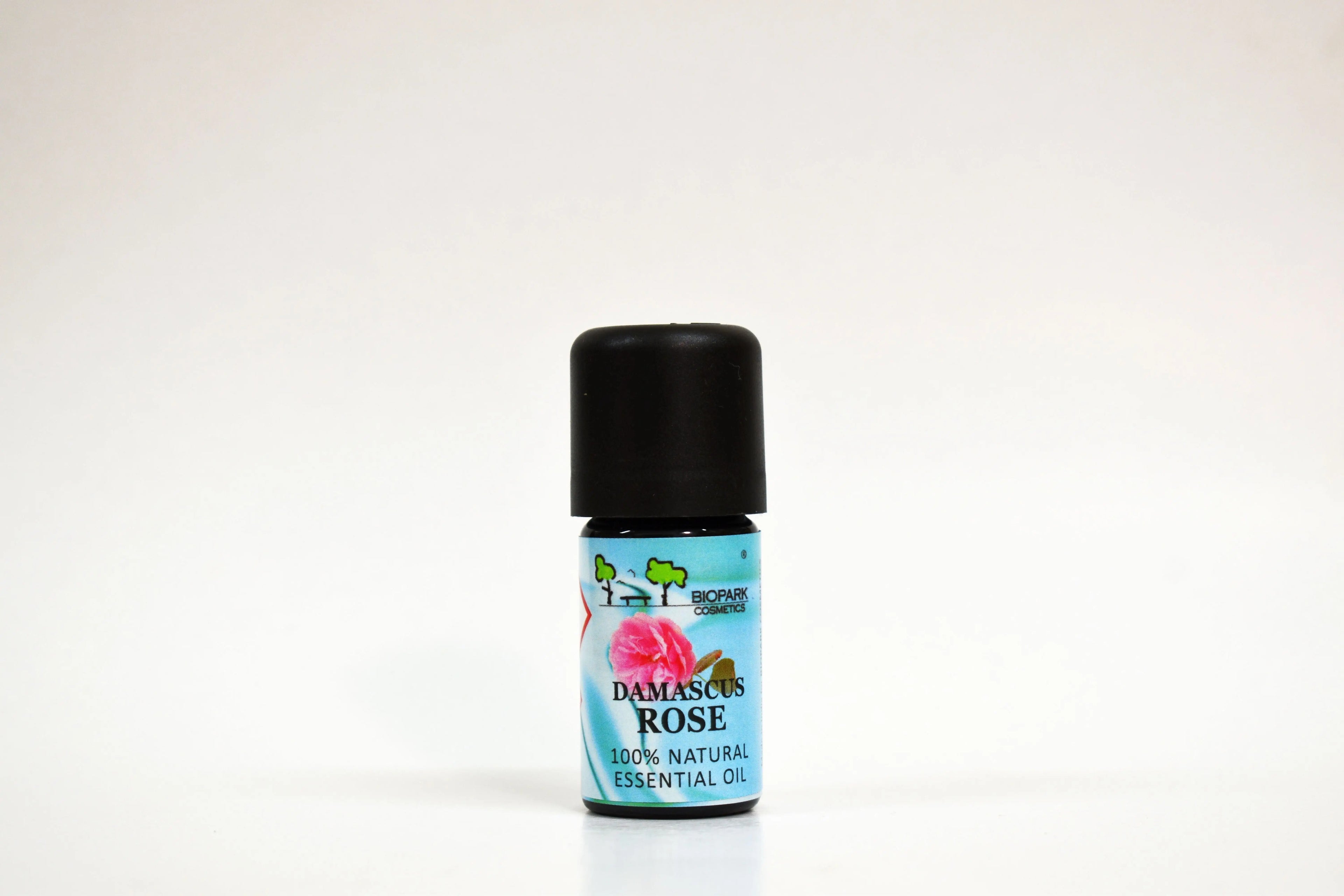 Bottle of Damascus Rose essential oil on a white background