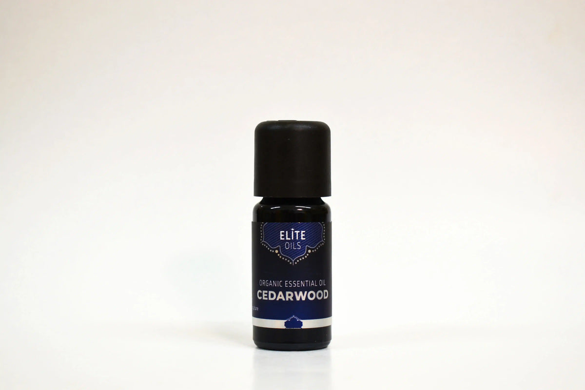 Bottle of Elite Oils Cedarwood essential oil on a white background