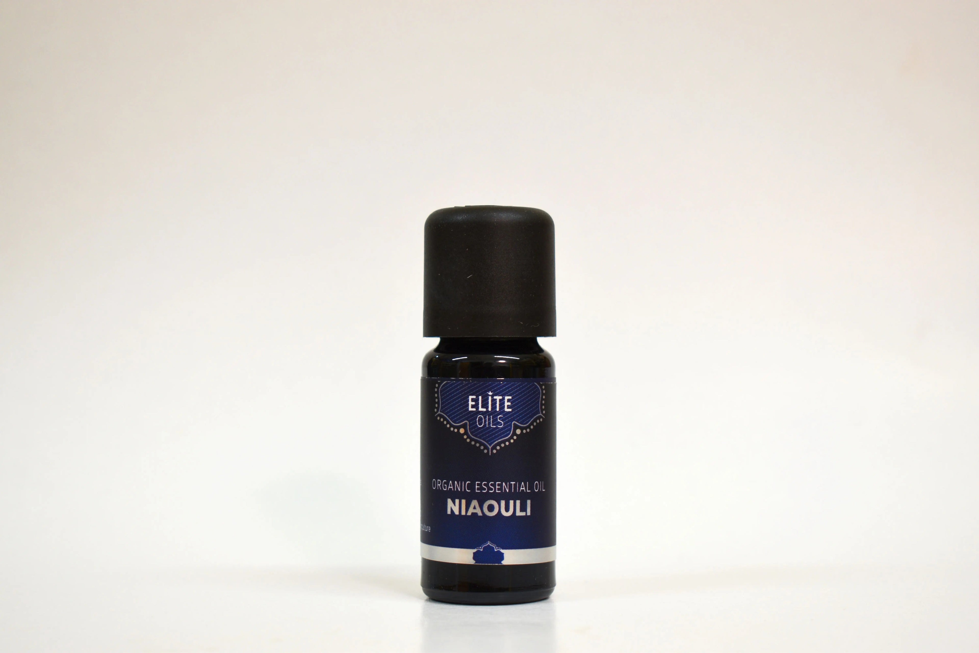 Bottle of Elite Oils Niaouli essential oil on a white background
