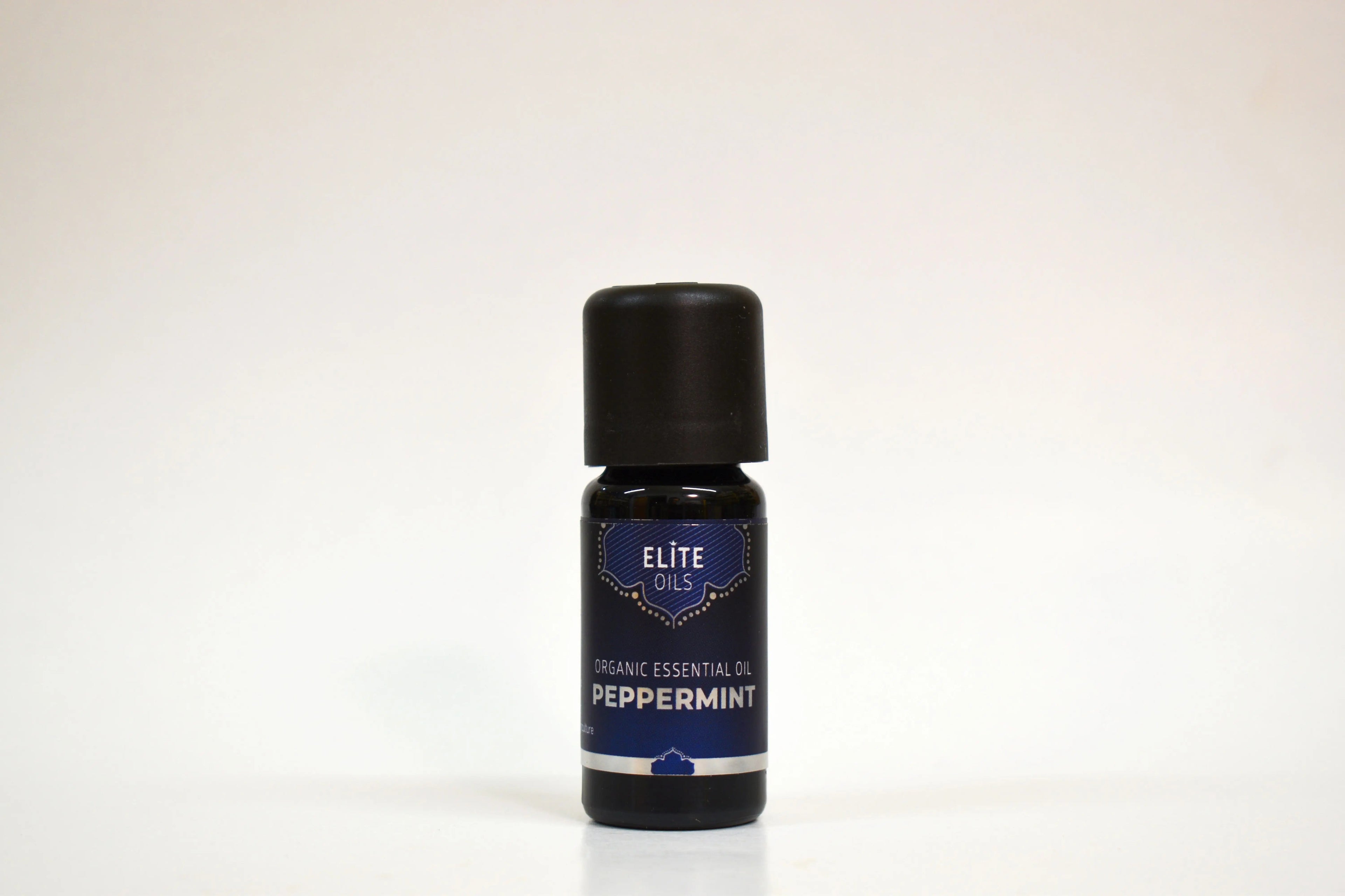 Peppermint essential oil bottle by Elite Oils on a white background