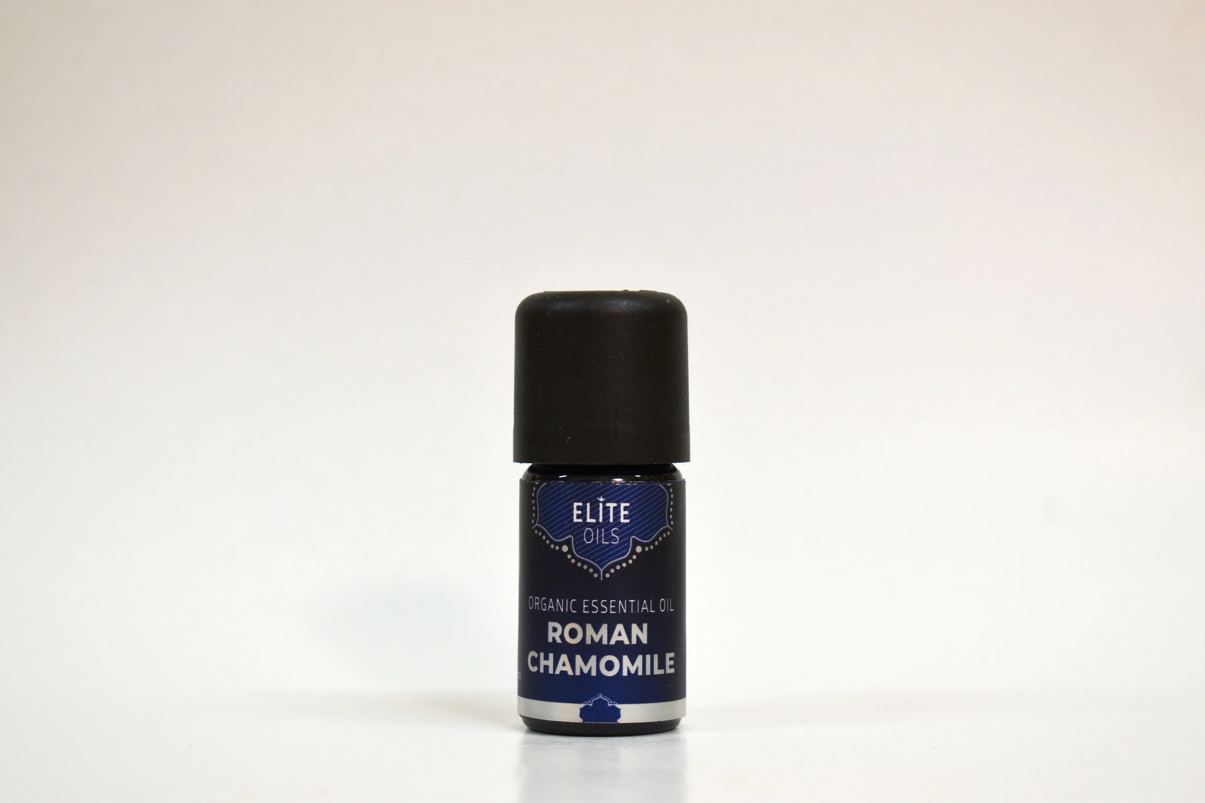 Bottle of Elite Oils Roman Chamomile essential oil on a white background