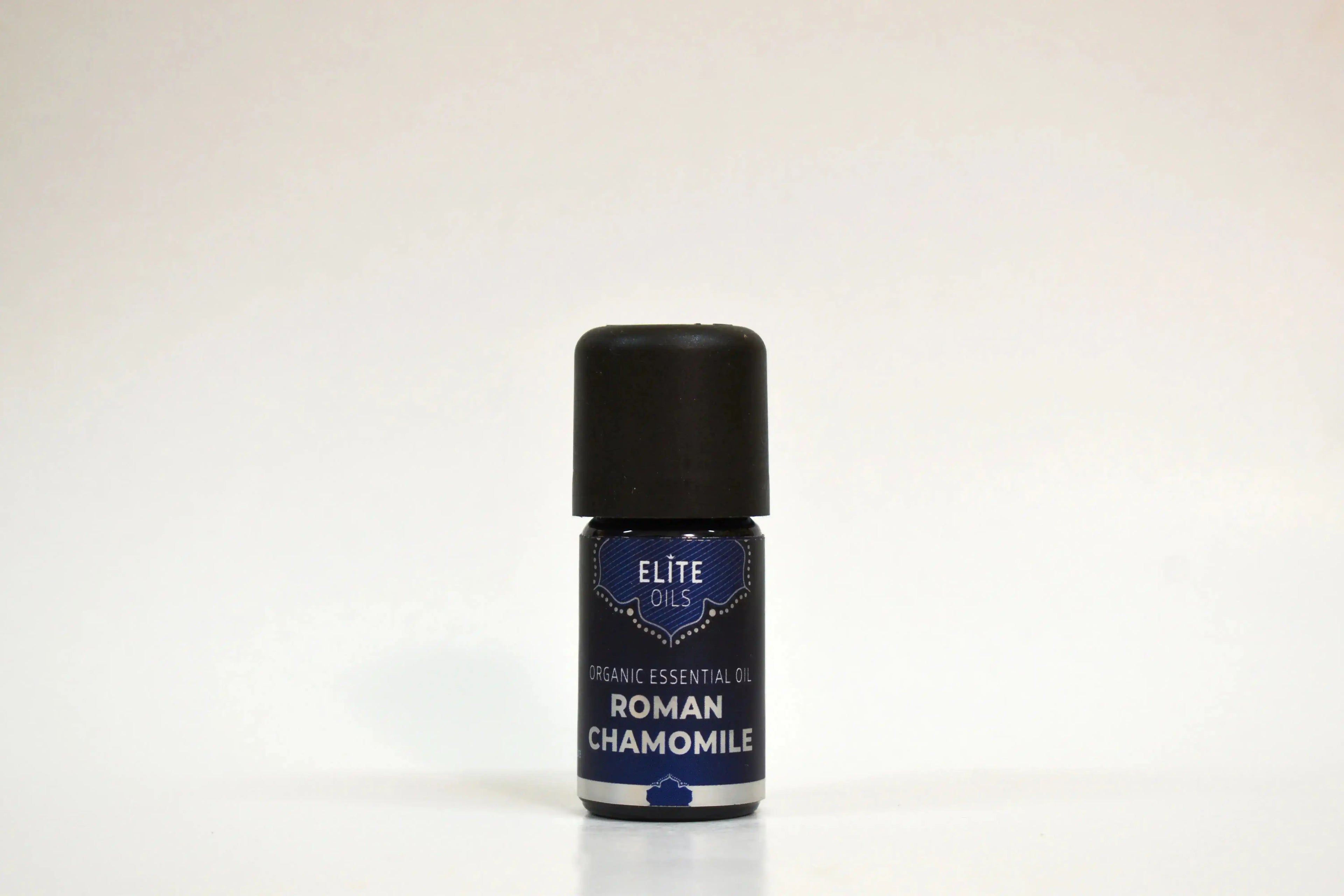 Bottle of Elite Oils Roman Chamomile essential oil on a white background
