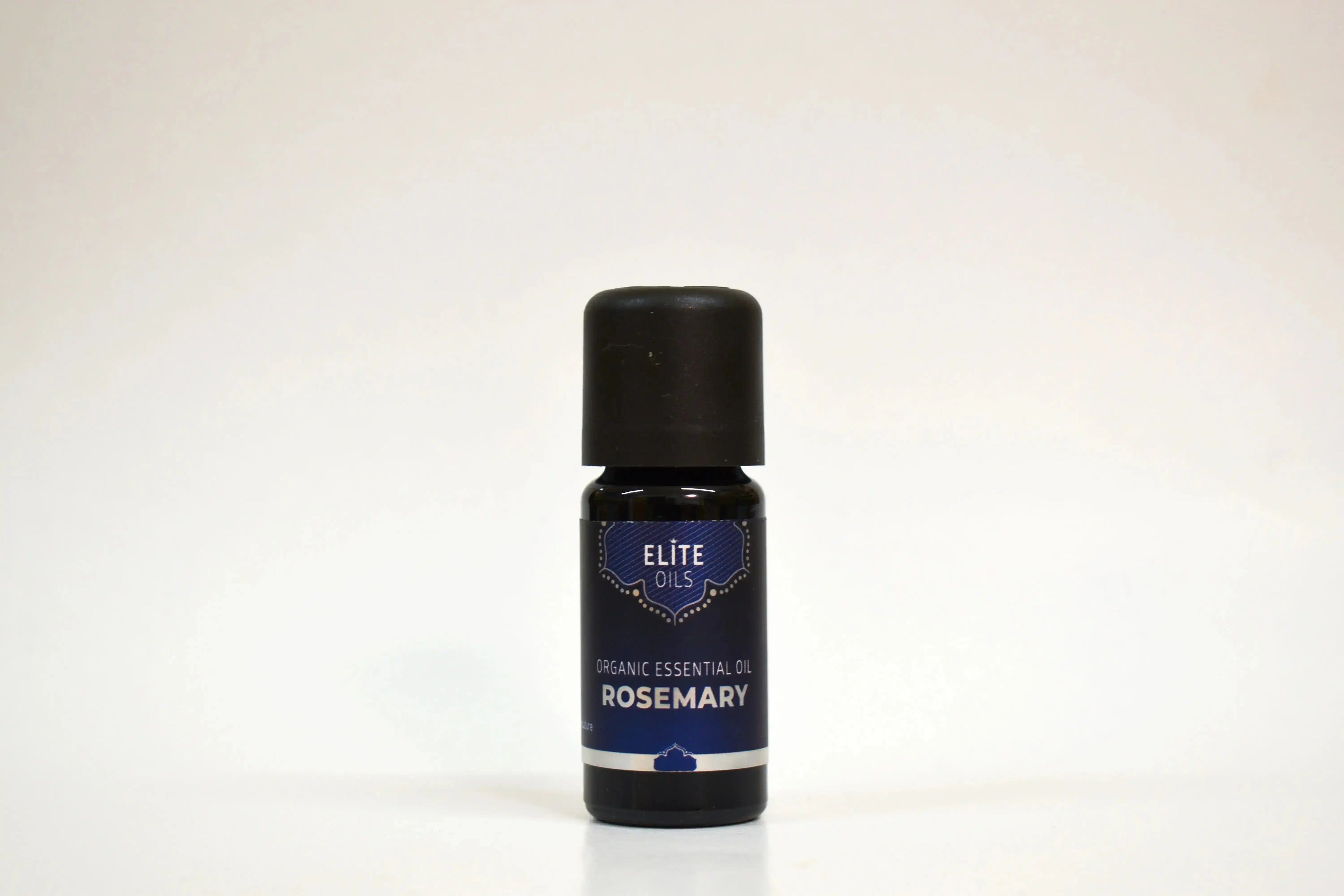 Bottle of Elite Oils Rosemary essential oil on a white background