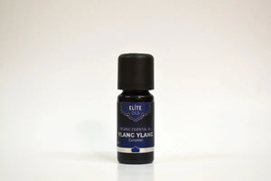 Bottle of Ylang Ylang essential oil on a white background