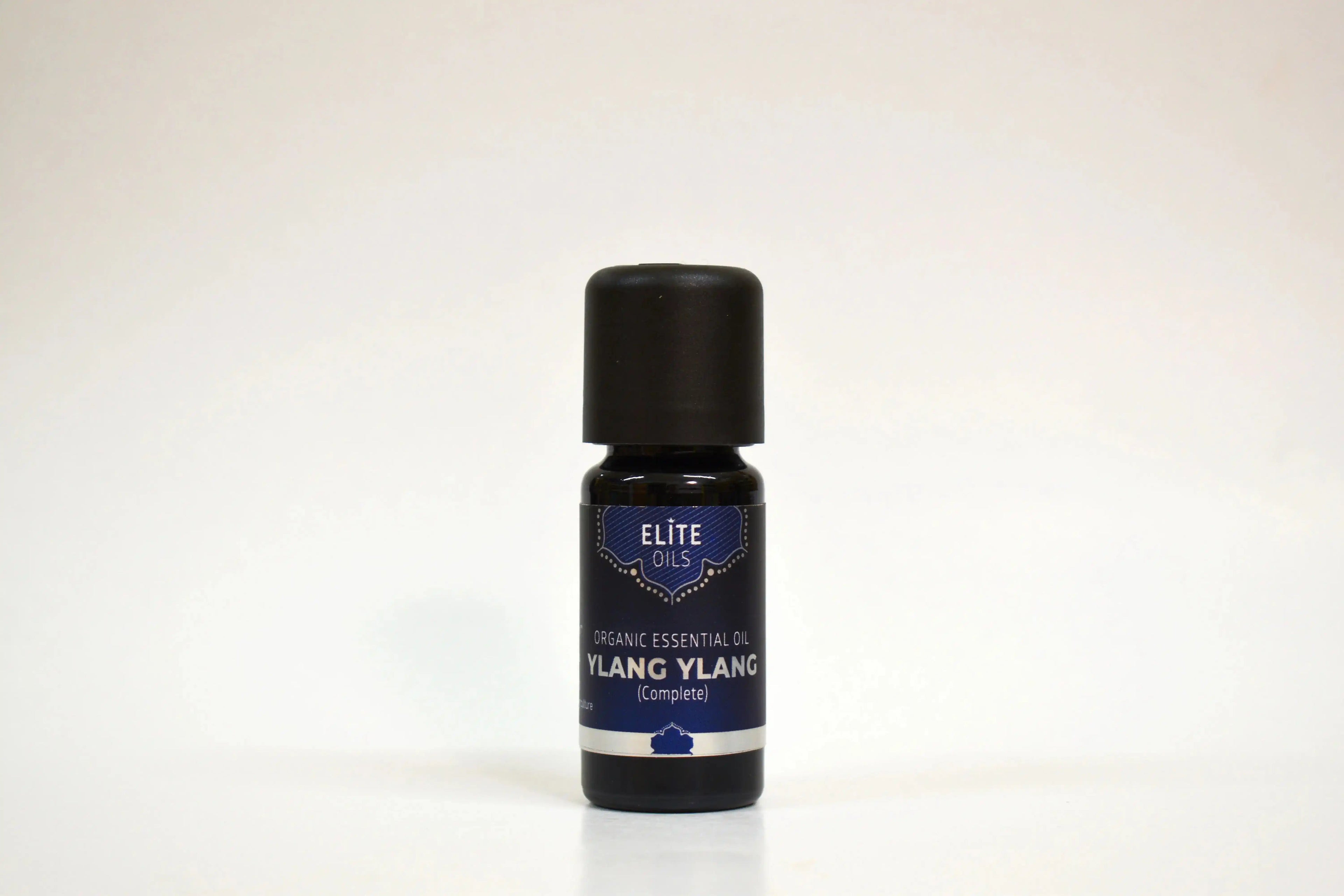 Bottle of Ylang Ylang essential oil on a white background
