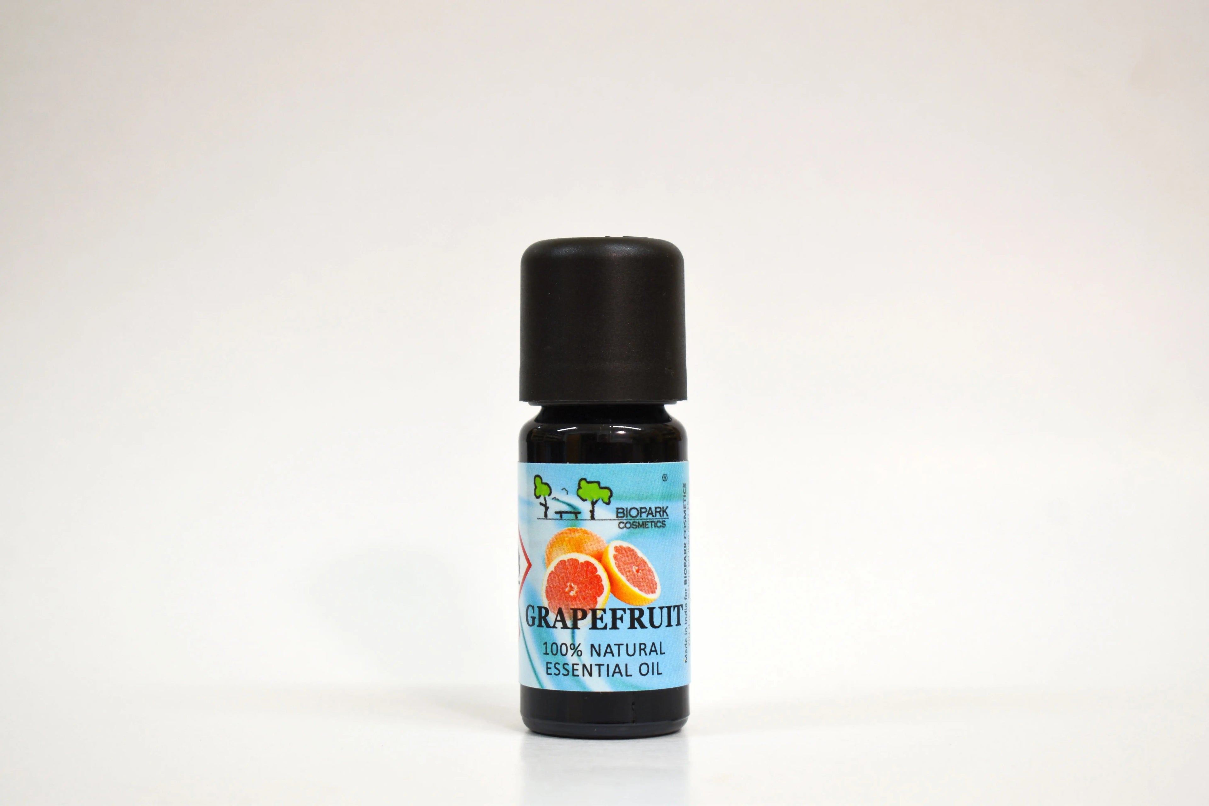Grapefruit essential oil bottle with a blue label on a white background