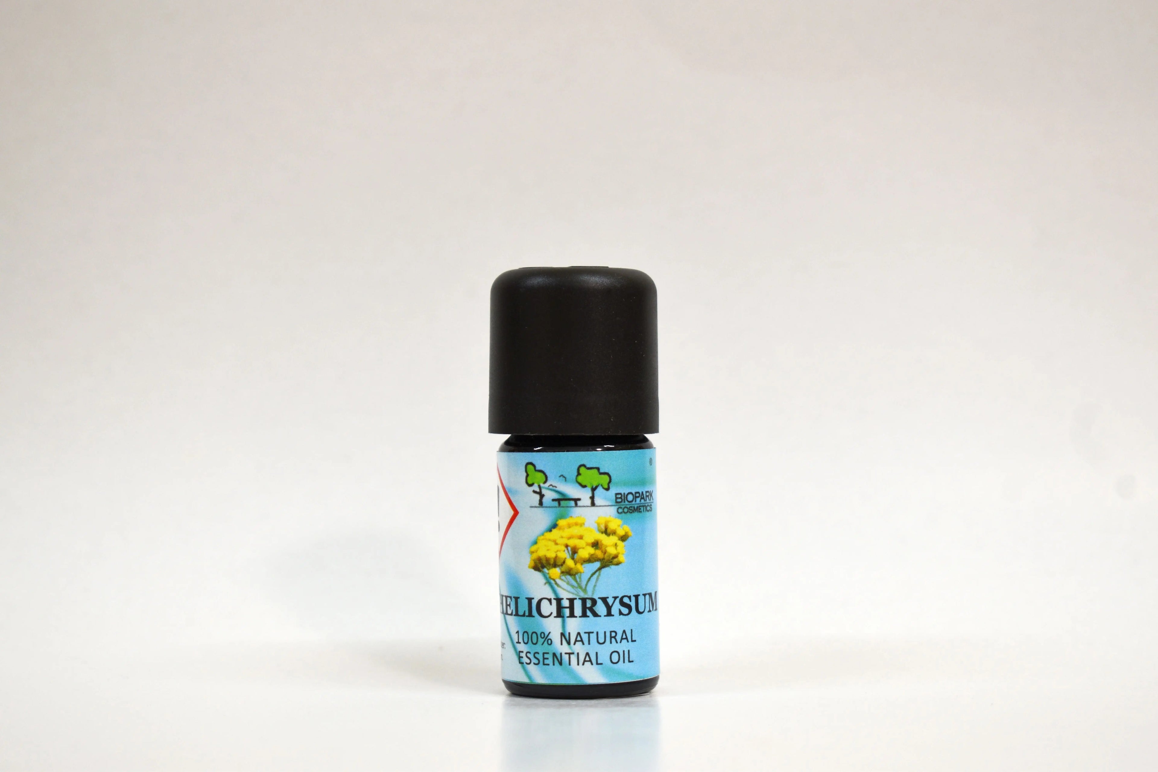 Bottle of Helichrysum essential oil on a white background
