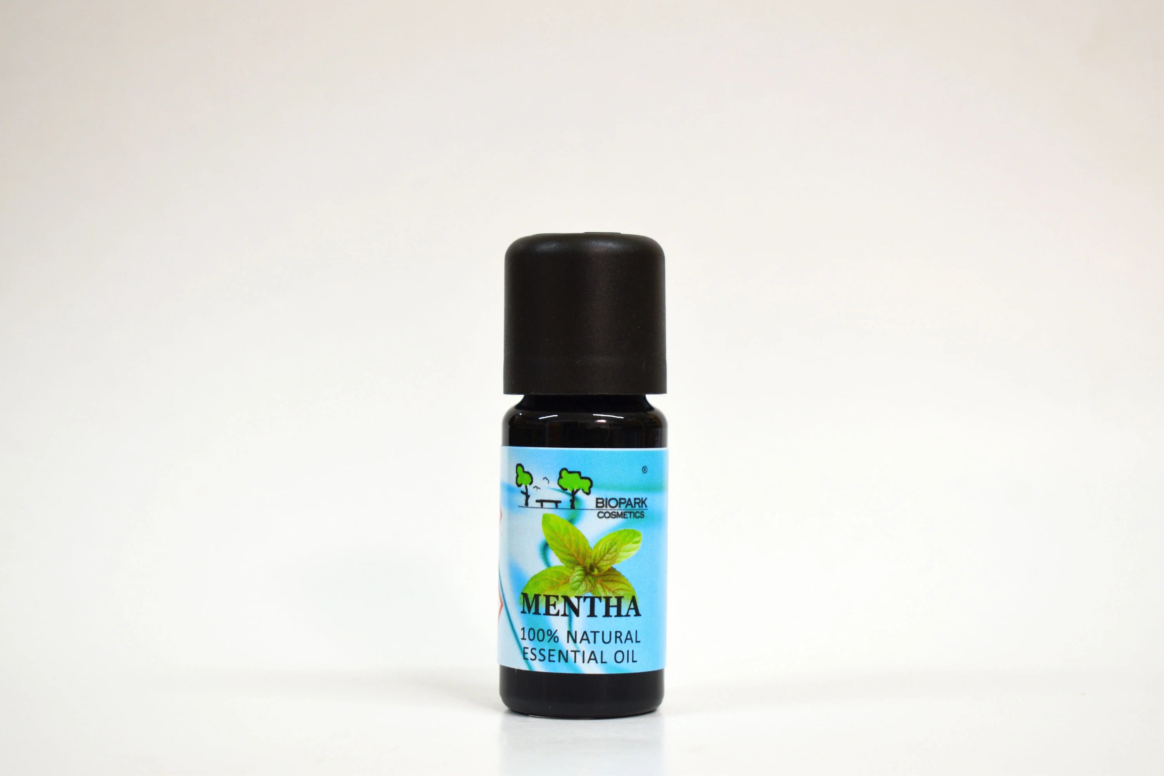 Bottle of mentha essential oil on a white background