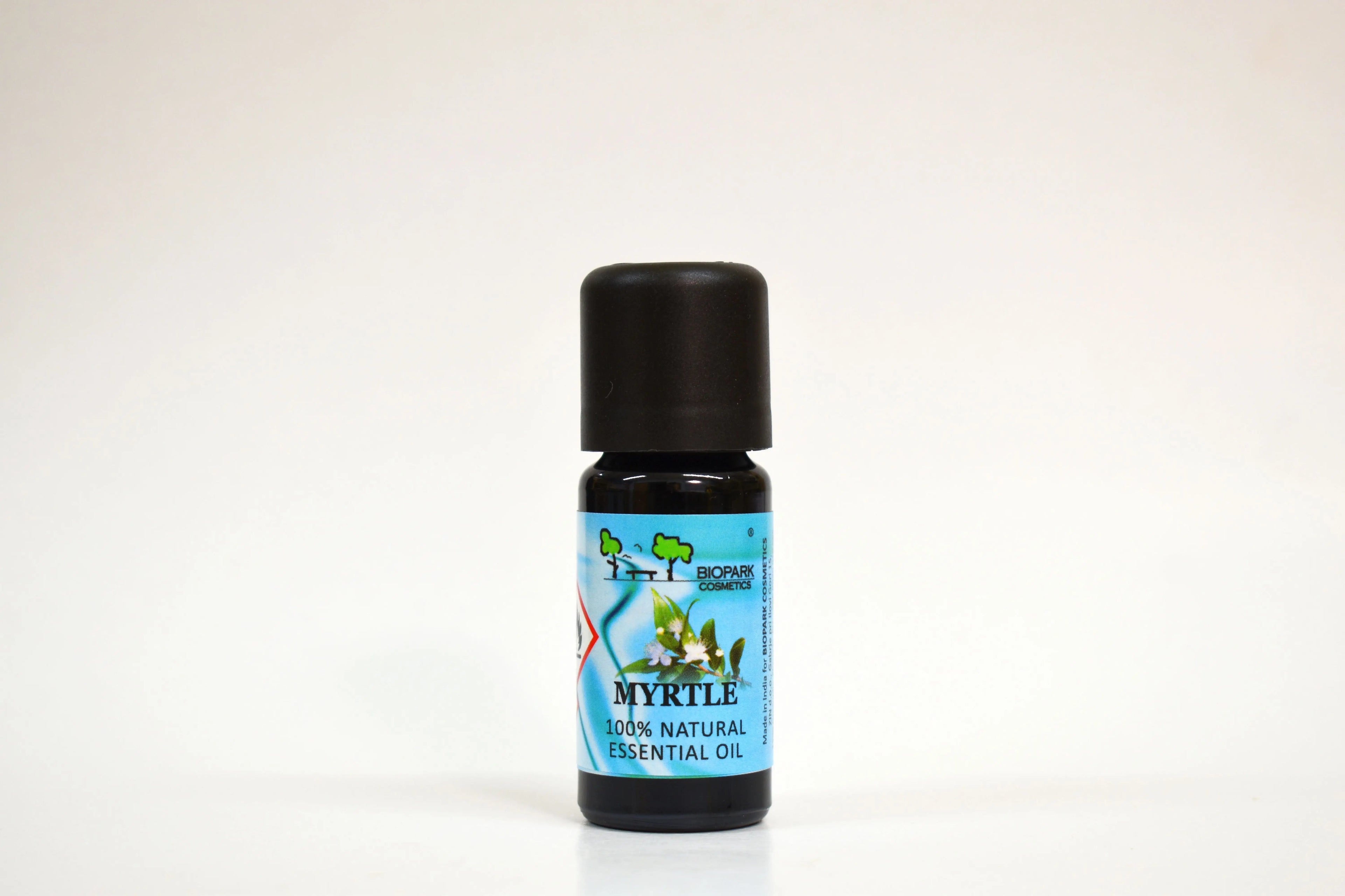 Bottle of myrtle essential oil on a white background