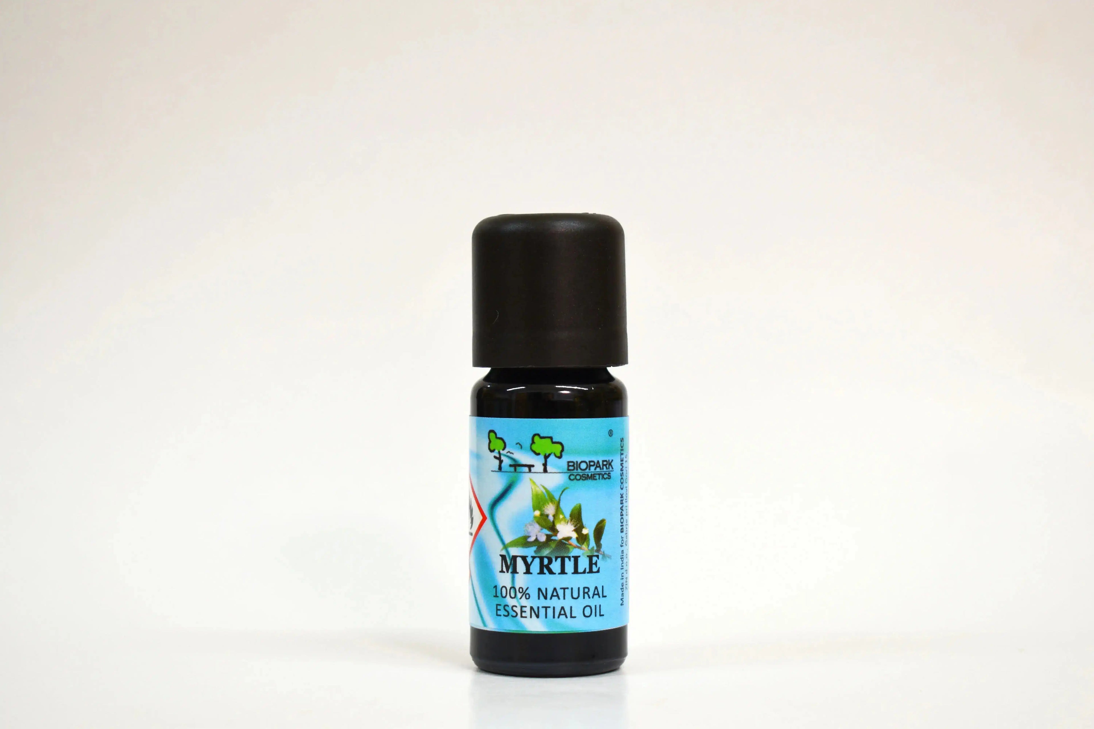Bottle of myrtle essential oil on a white background