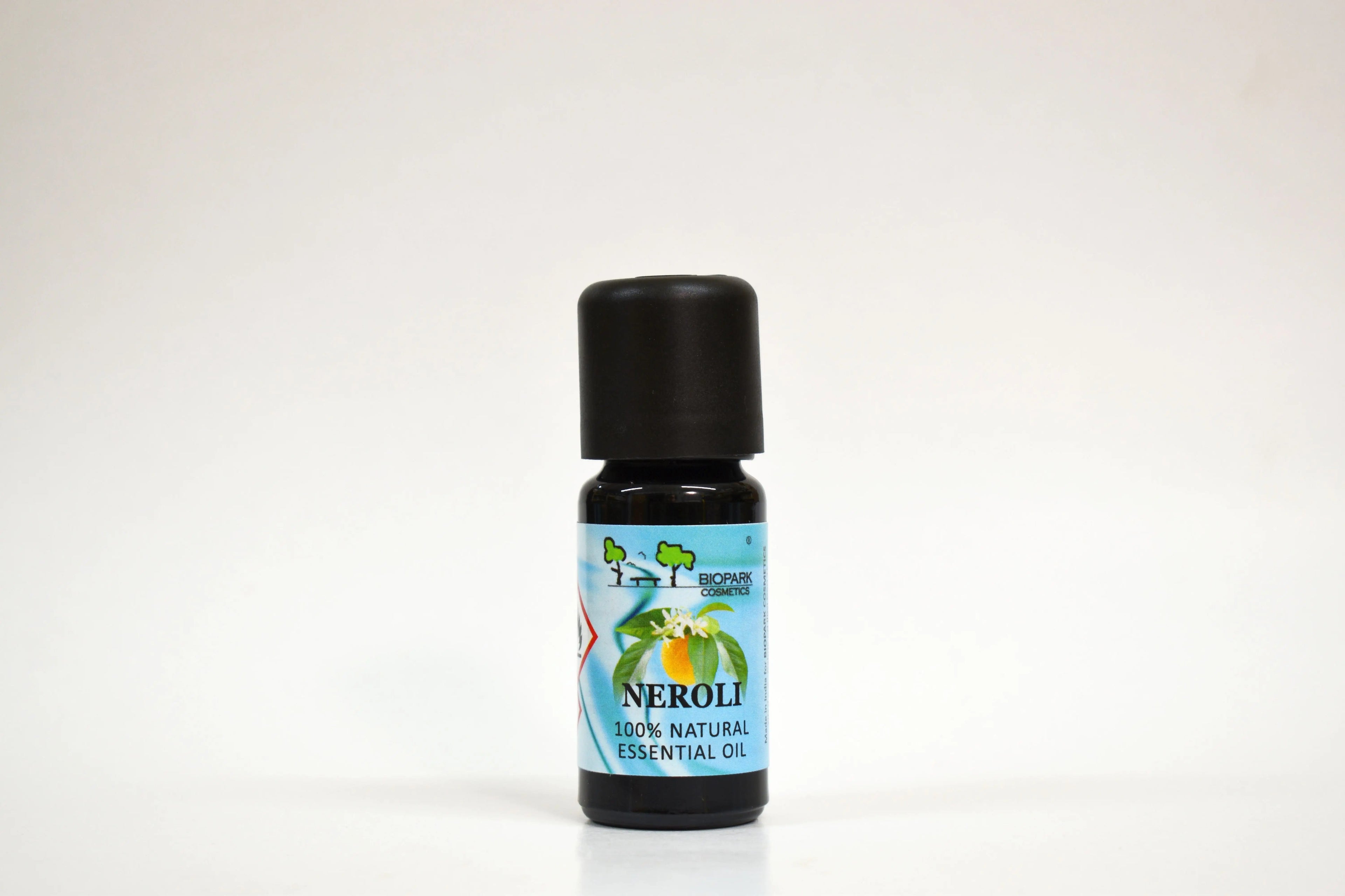 Bottle of Neroli essential oil on a white background