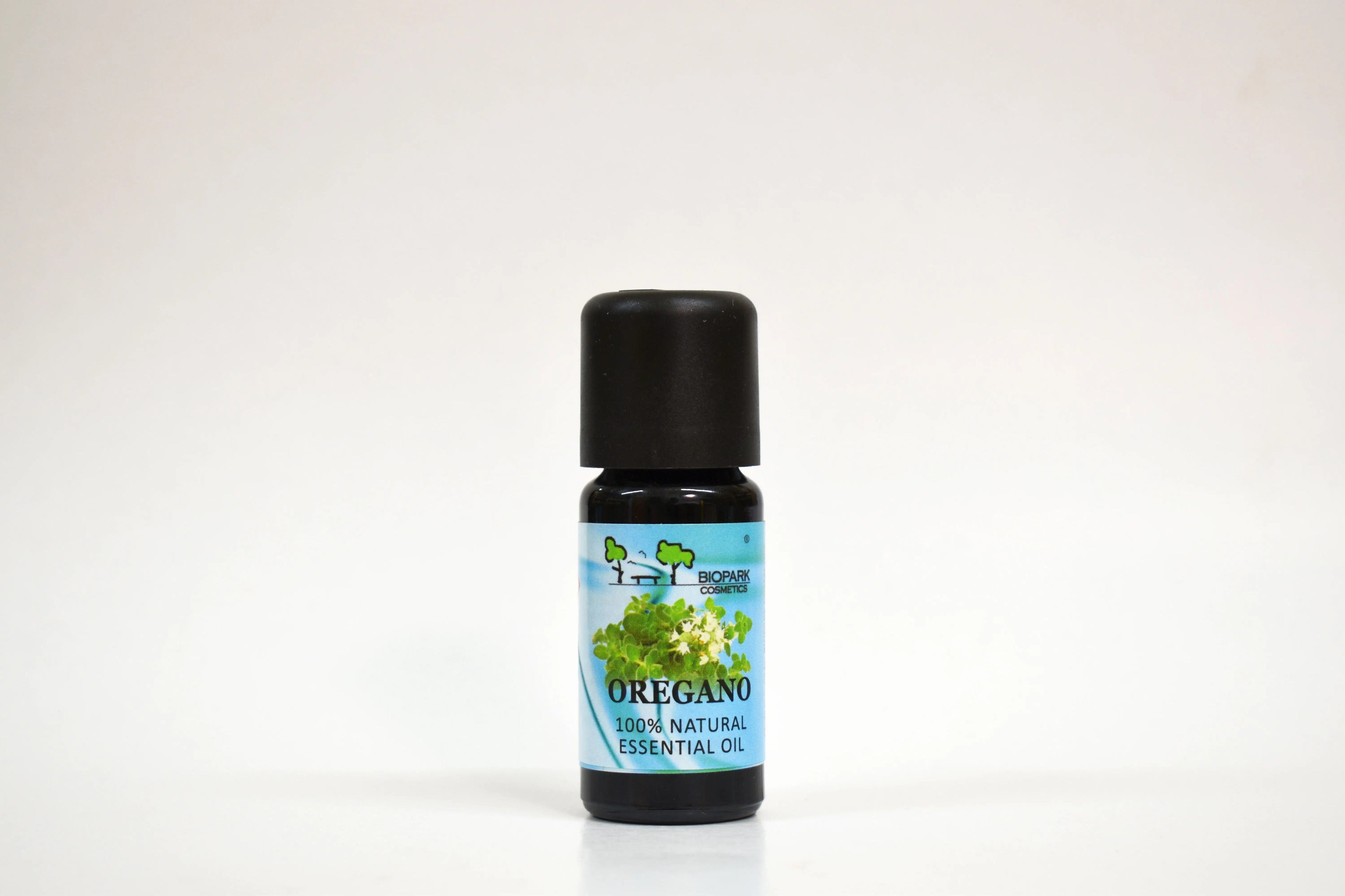 Bottle of oregano essential oil on a white background