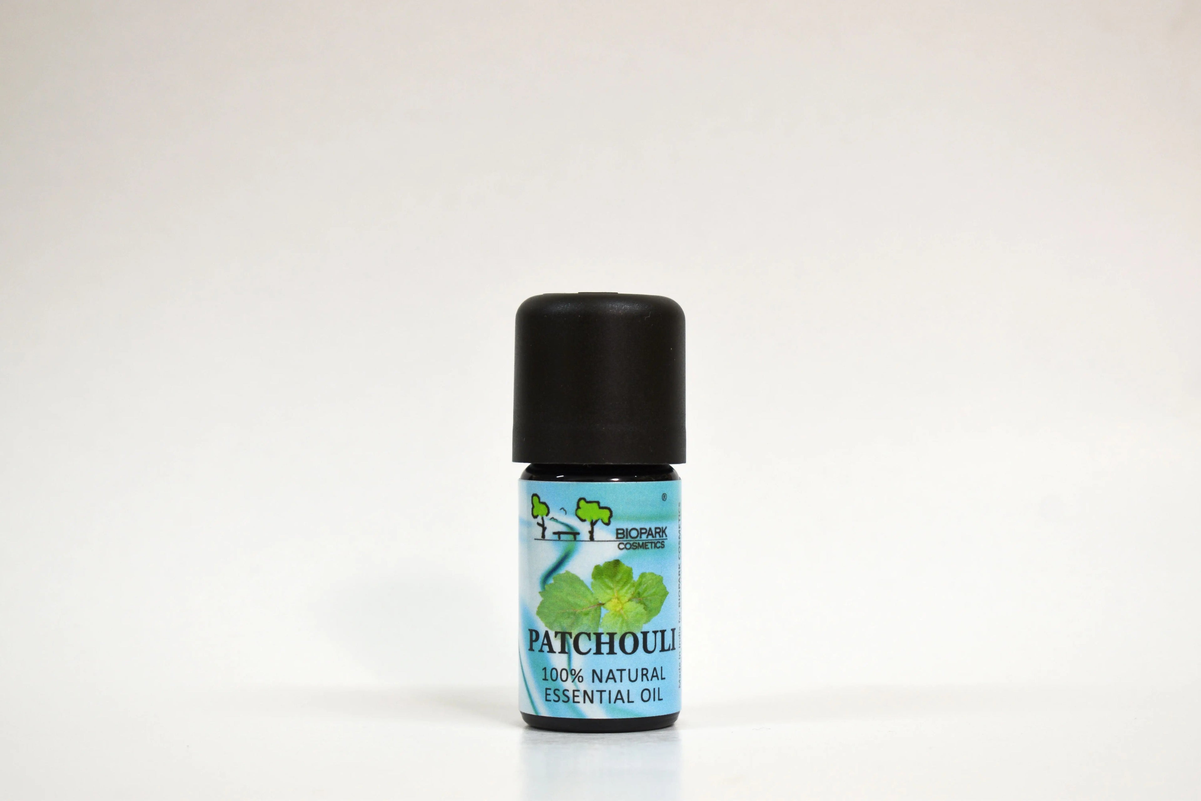 Patchouli essential oil bottle on a white background