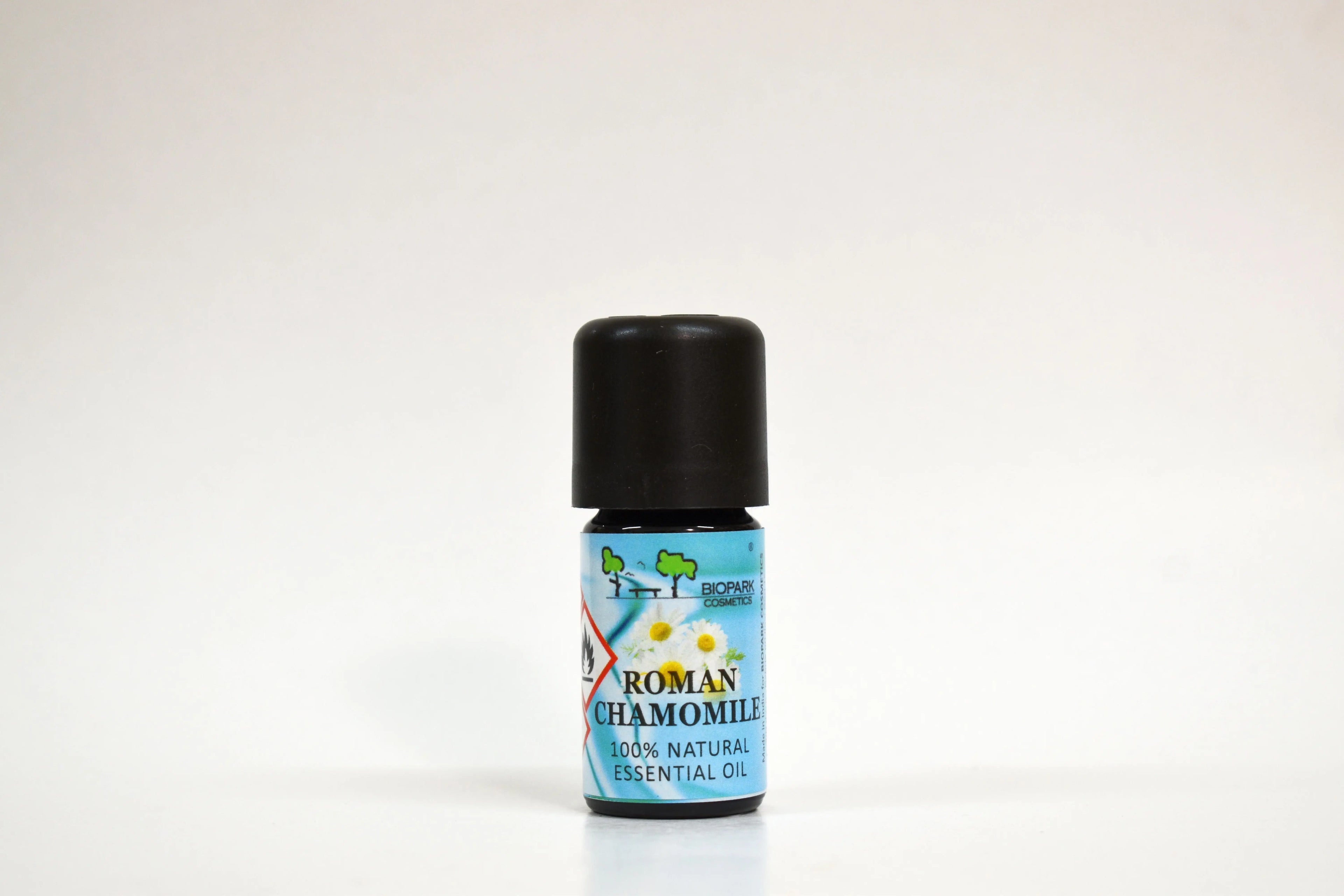 Bottle of Roman Chamomile essential oil on a white background
