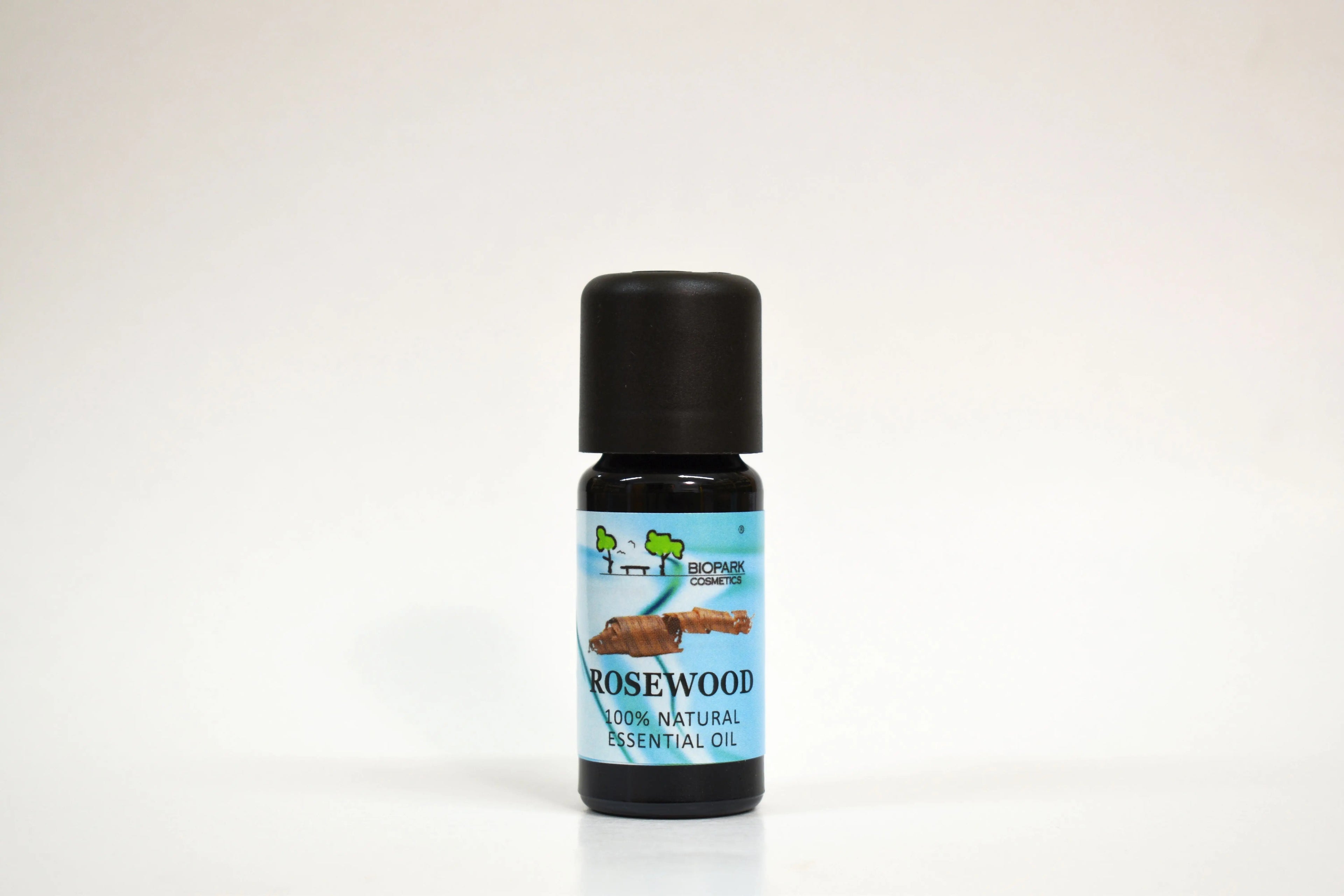 Bottle of rosewood essential oil on a white background