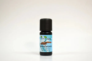 Bottle of rosewood essential oil on a white background