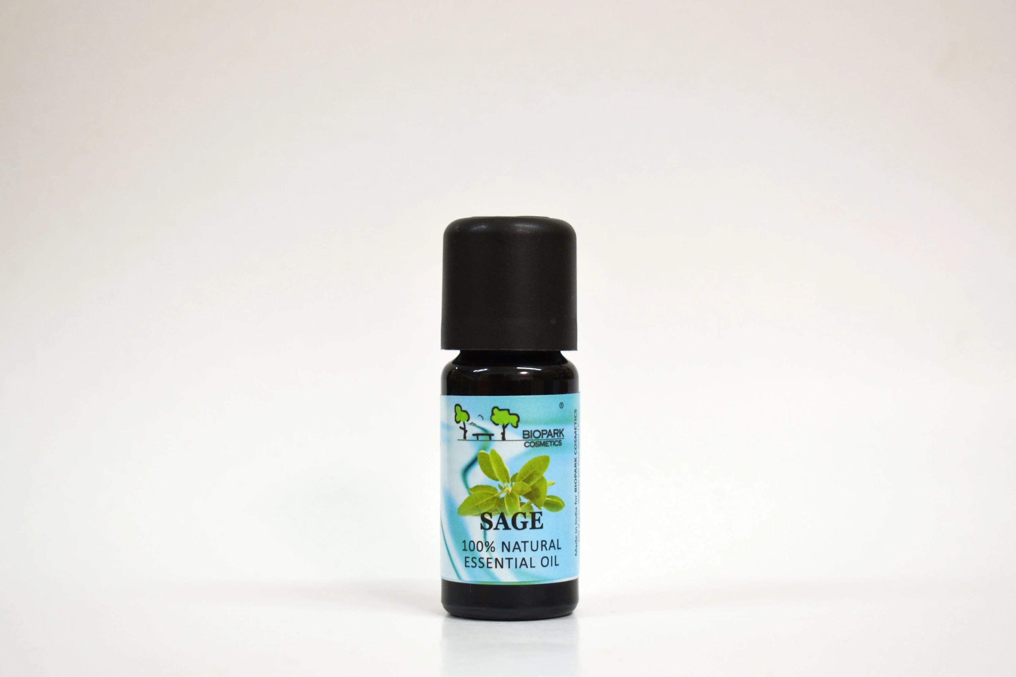 Bottle of Sage essential oil with a black cap on a white background