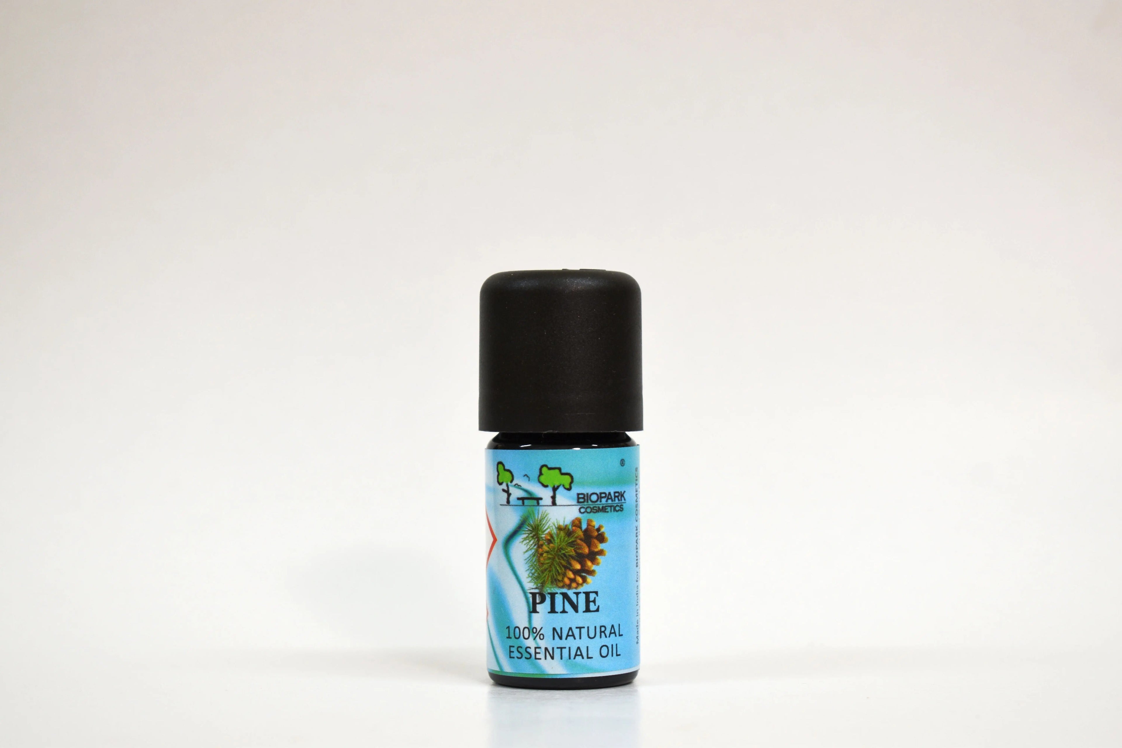 Bottle of pine essential oil on a white background