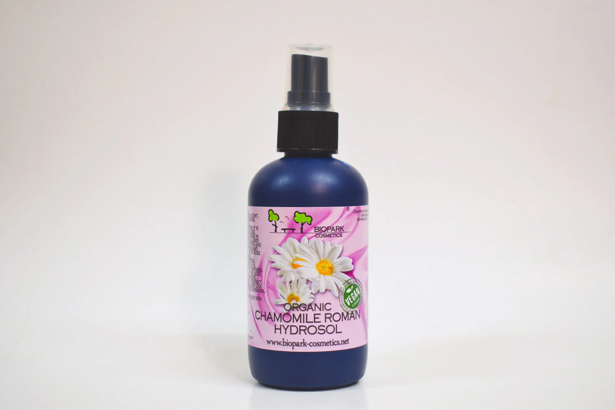 Bottle of organic chamomile Roman hydrosol with a spray nozzle on a white background