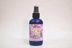 Bottle of organic chamomile Roman hydrosol with a spray nozzle on a white background