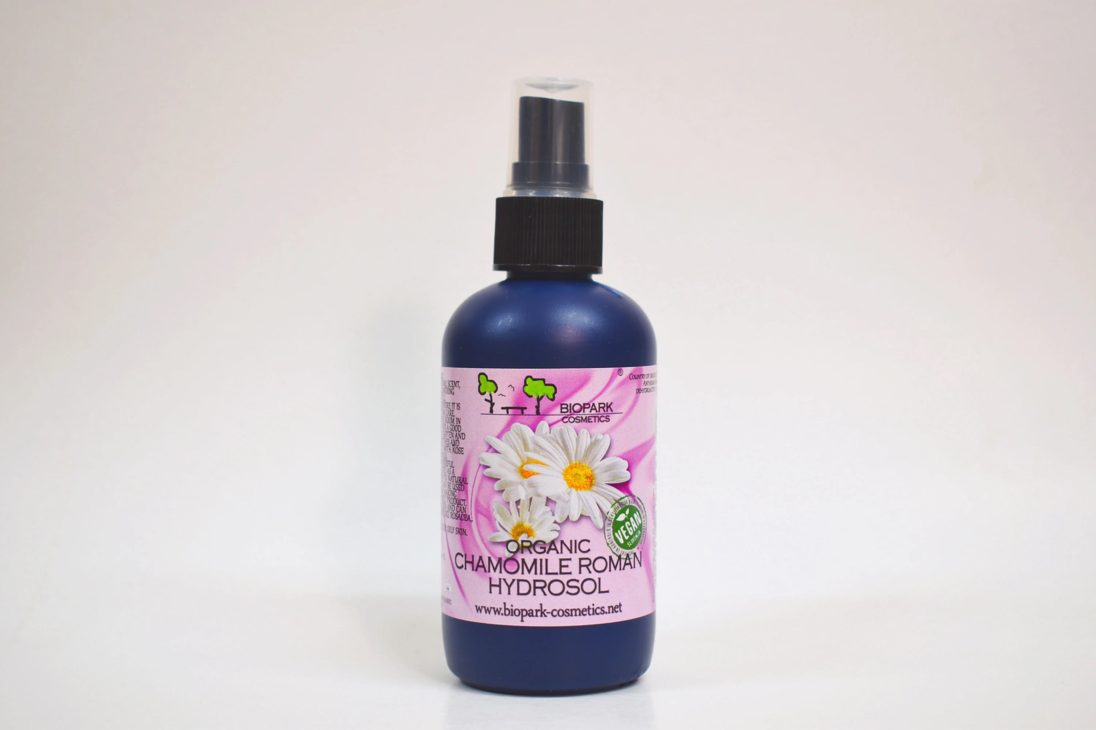 Bottle of organic chamomile Roman hydrosol with a spray nozzle on a white background