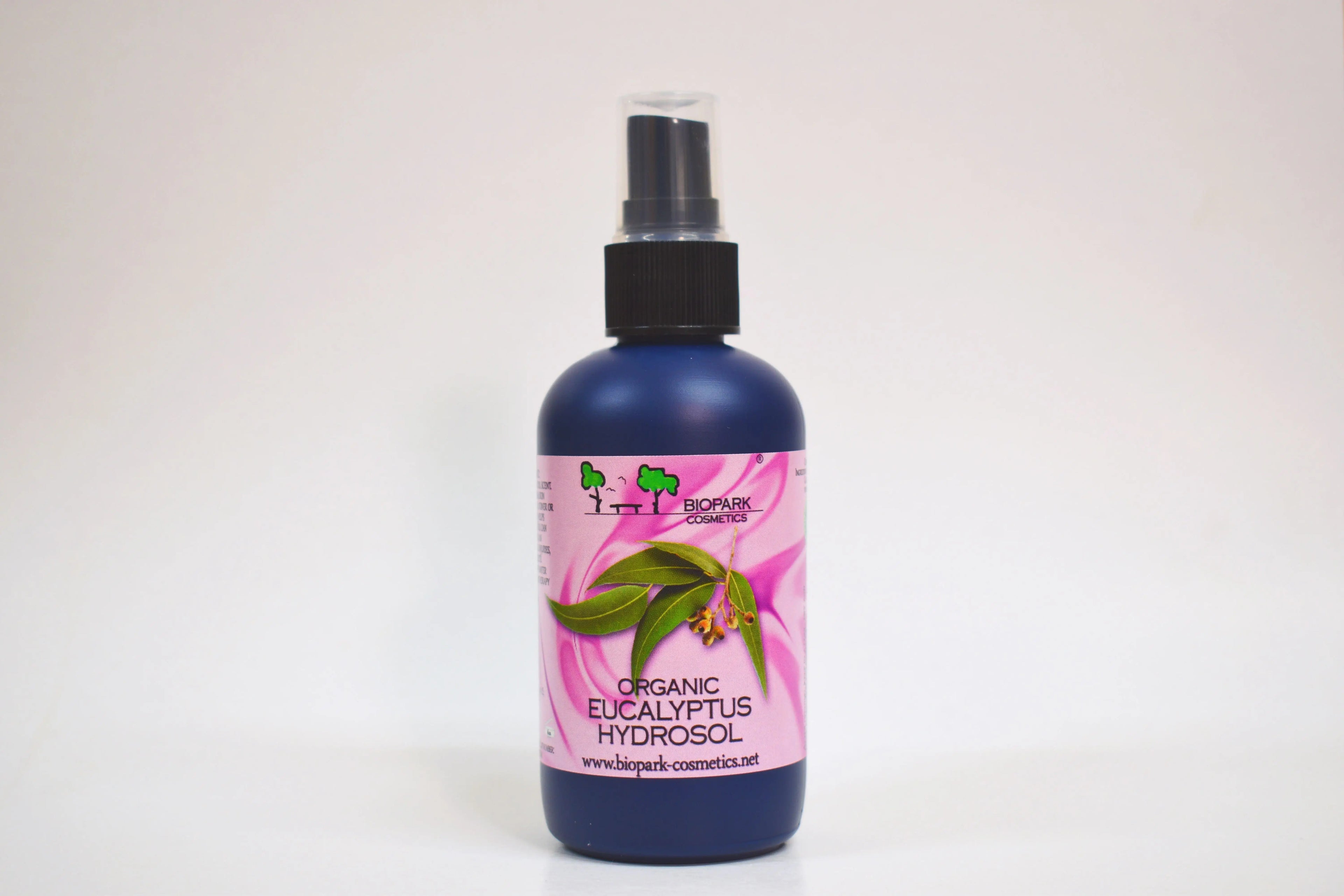 Bottle of organic eucalyptus hydrosol with a pink label on a white background