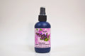 Bottle of organic clary sage hydrosol with a floral label on a white background