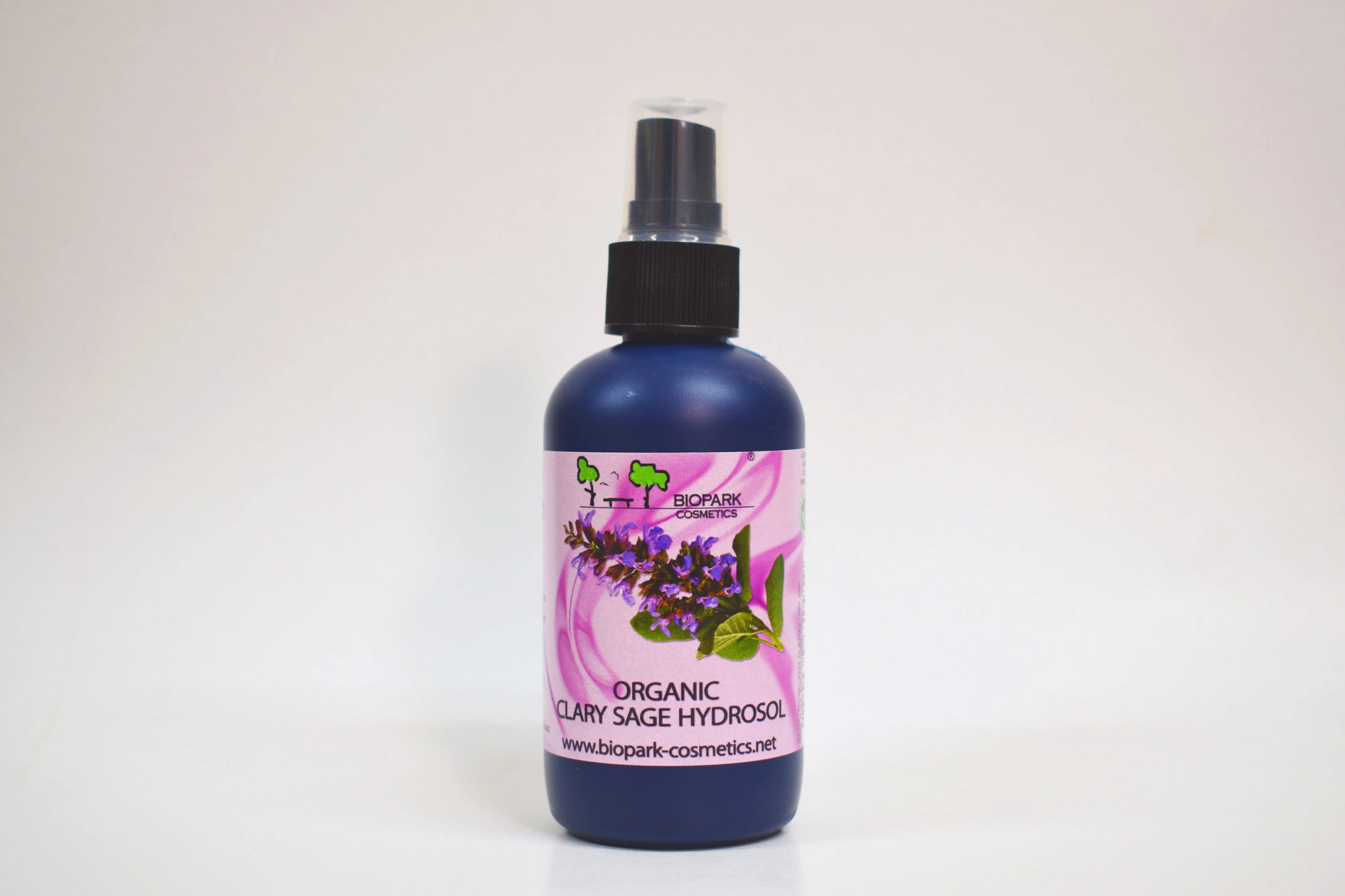 Bottle of organic clary sage hydrosol with a floral label on a white background