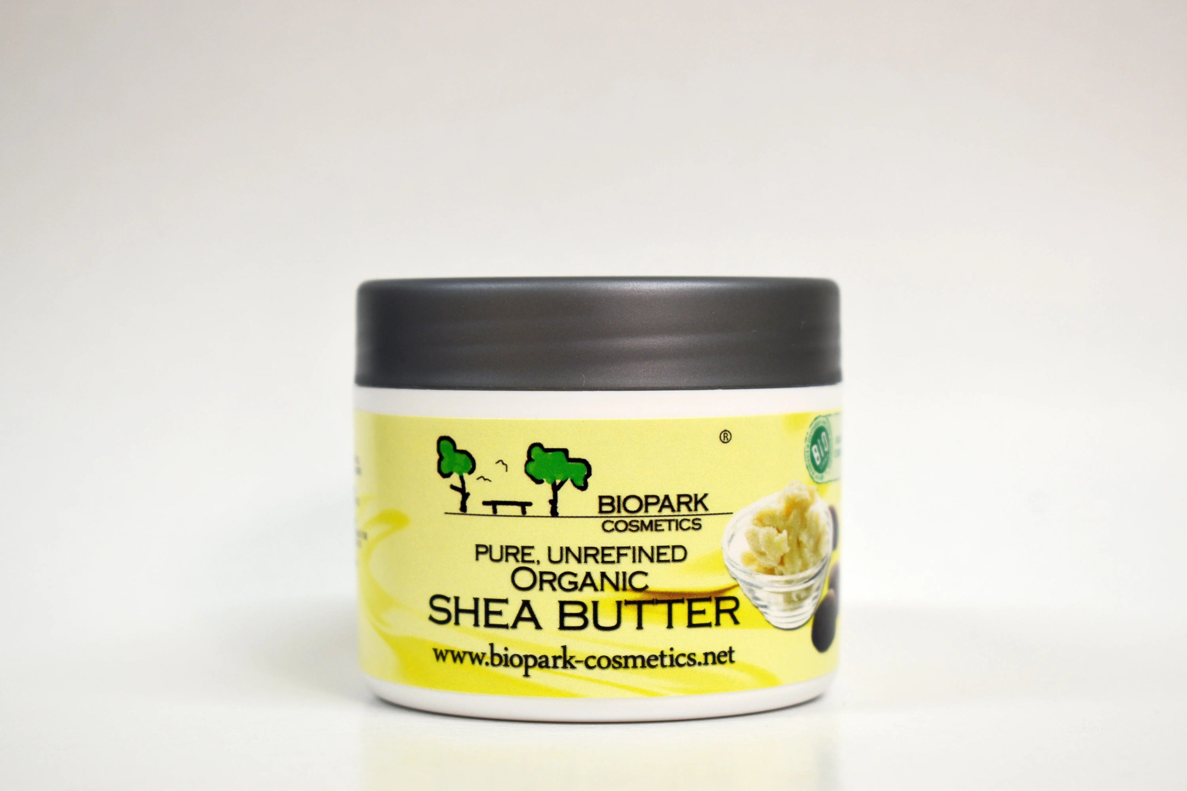 Jar of pure unrefined organic shea butter with Biopark Cosmetics branding on a white background
