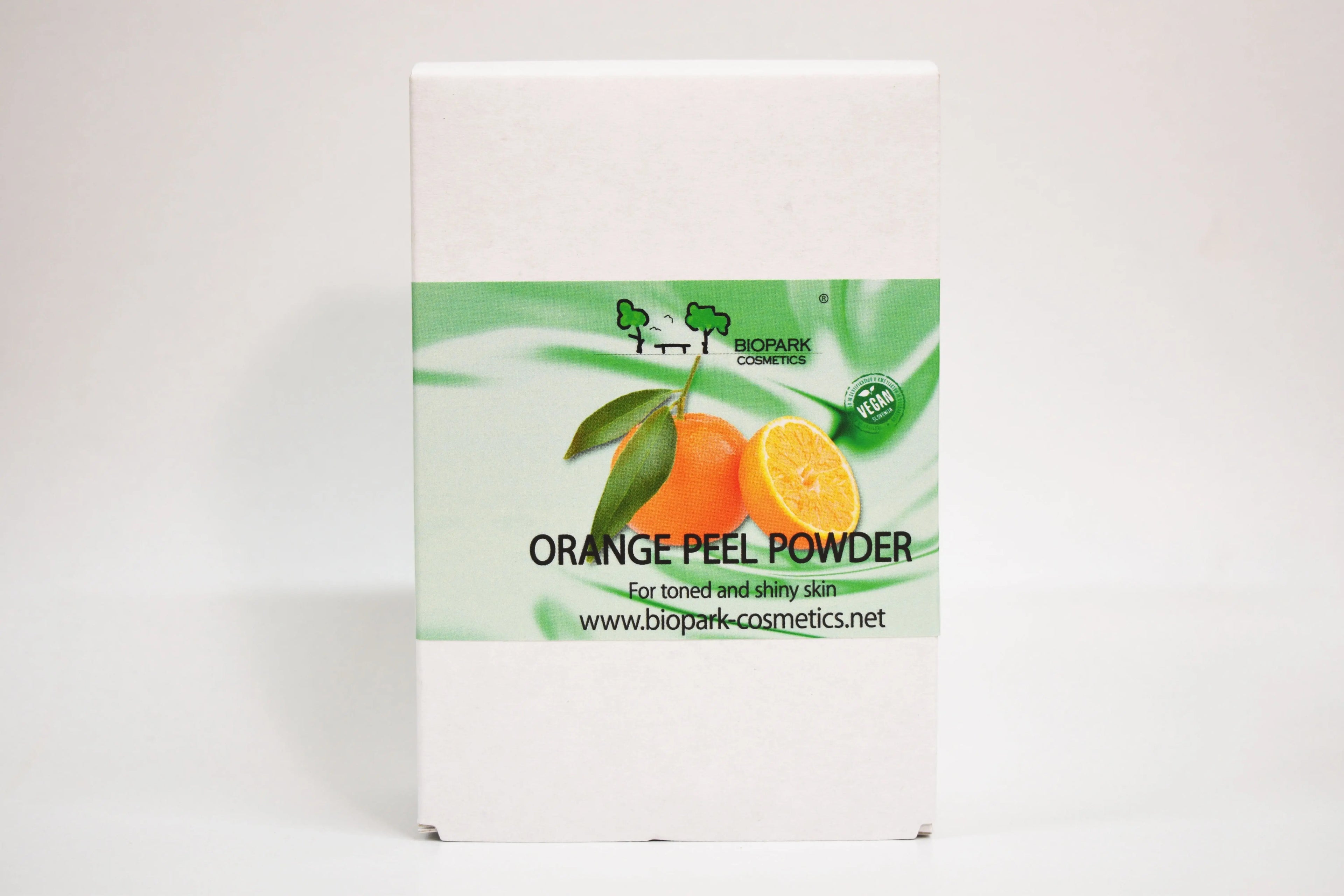 Box of orange peel powder with a green label on a white background