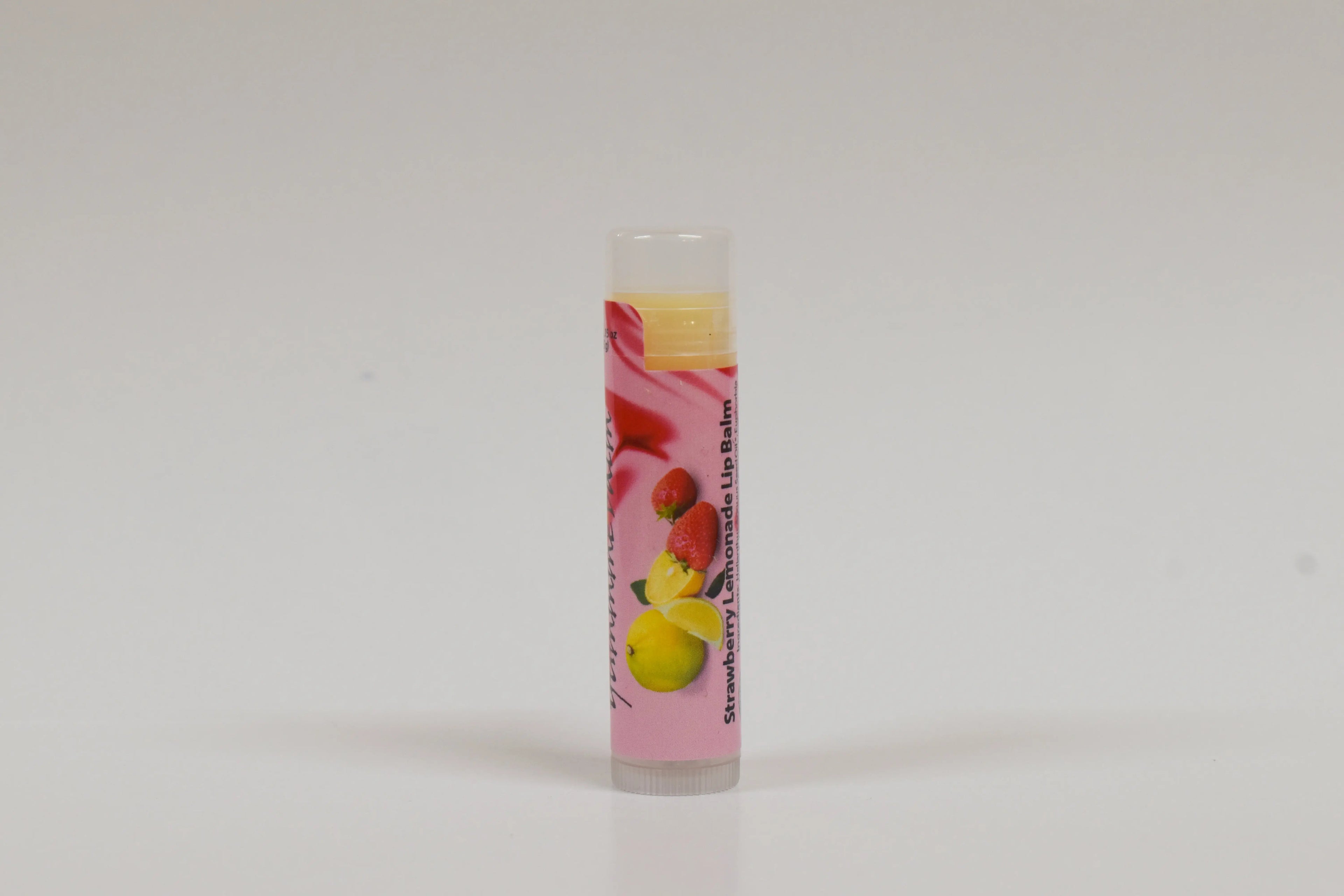 Lip balm with strawberry and lemon flavor on a white background