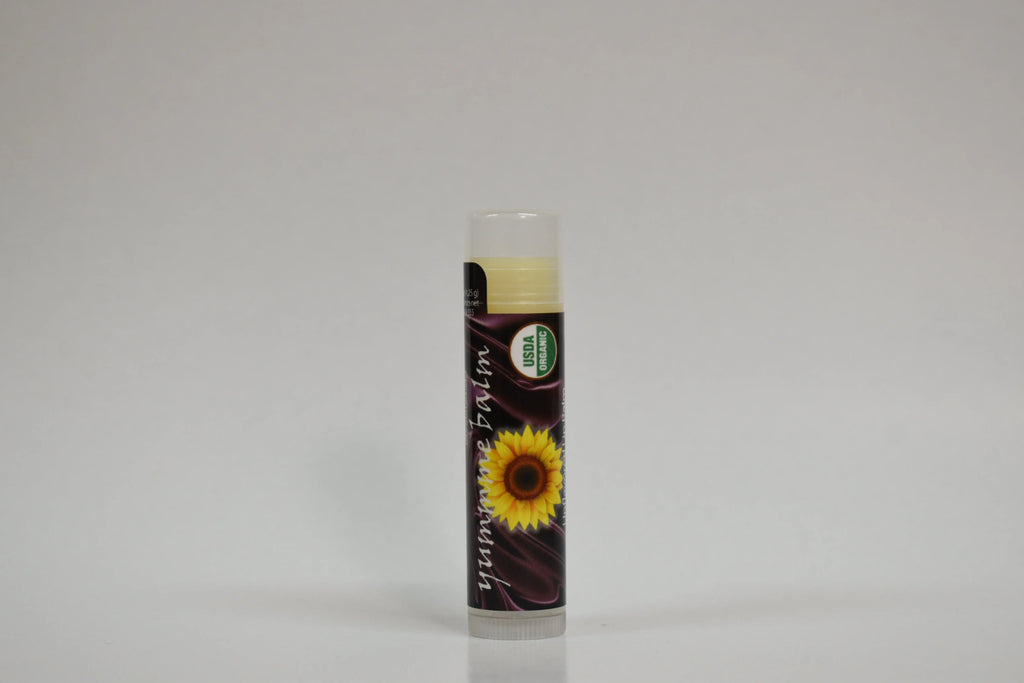 Lip balm with sunflower design on a gray background