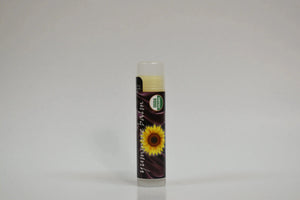 Lip balm with sunflower design on a gray background