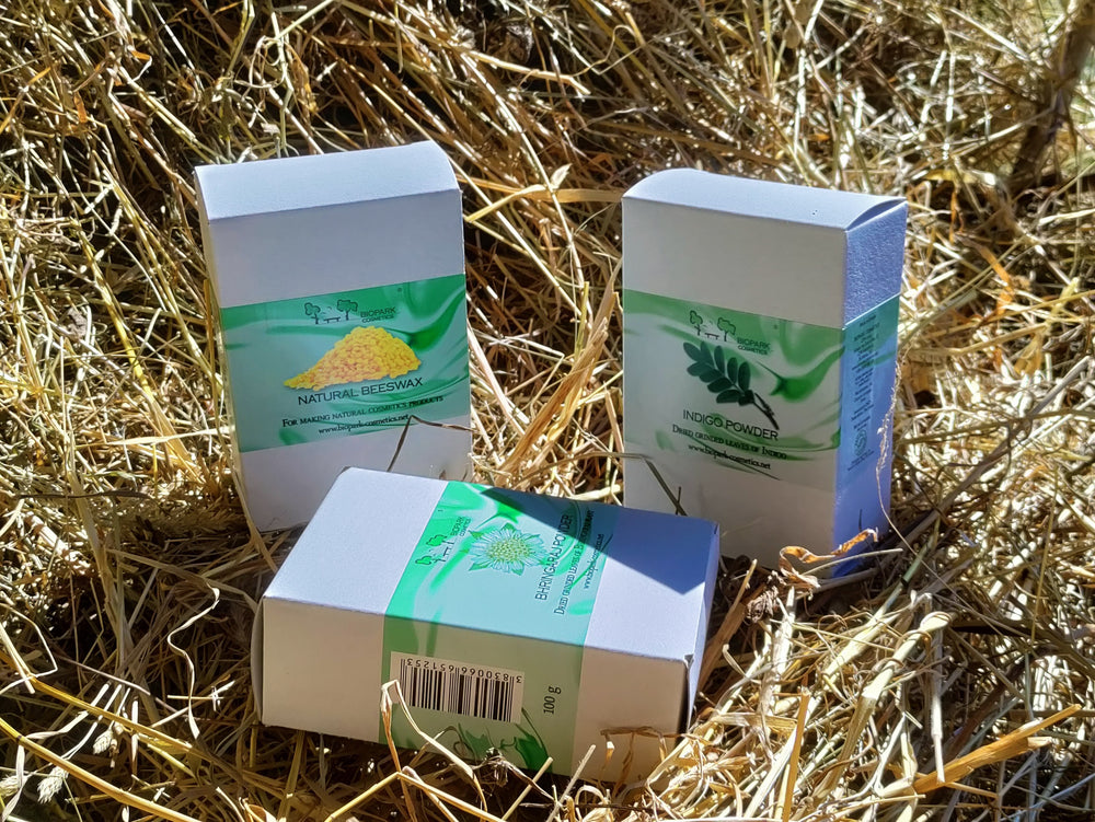 Three boxes of natural products on a bed of straw