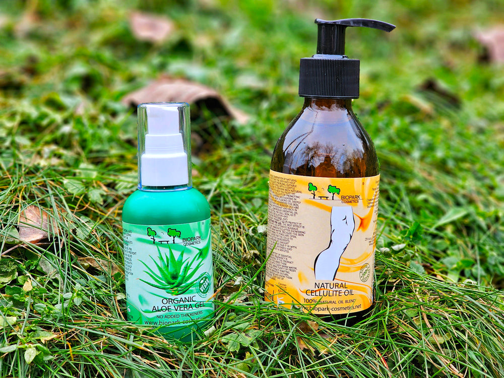 Two bottles of organic skincare products on grass